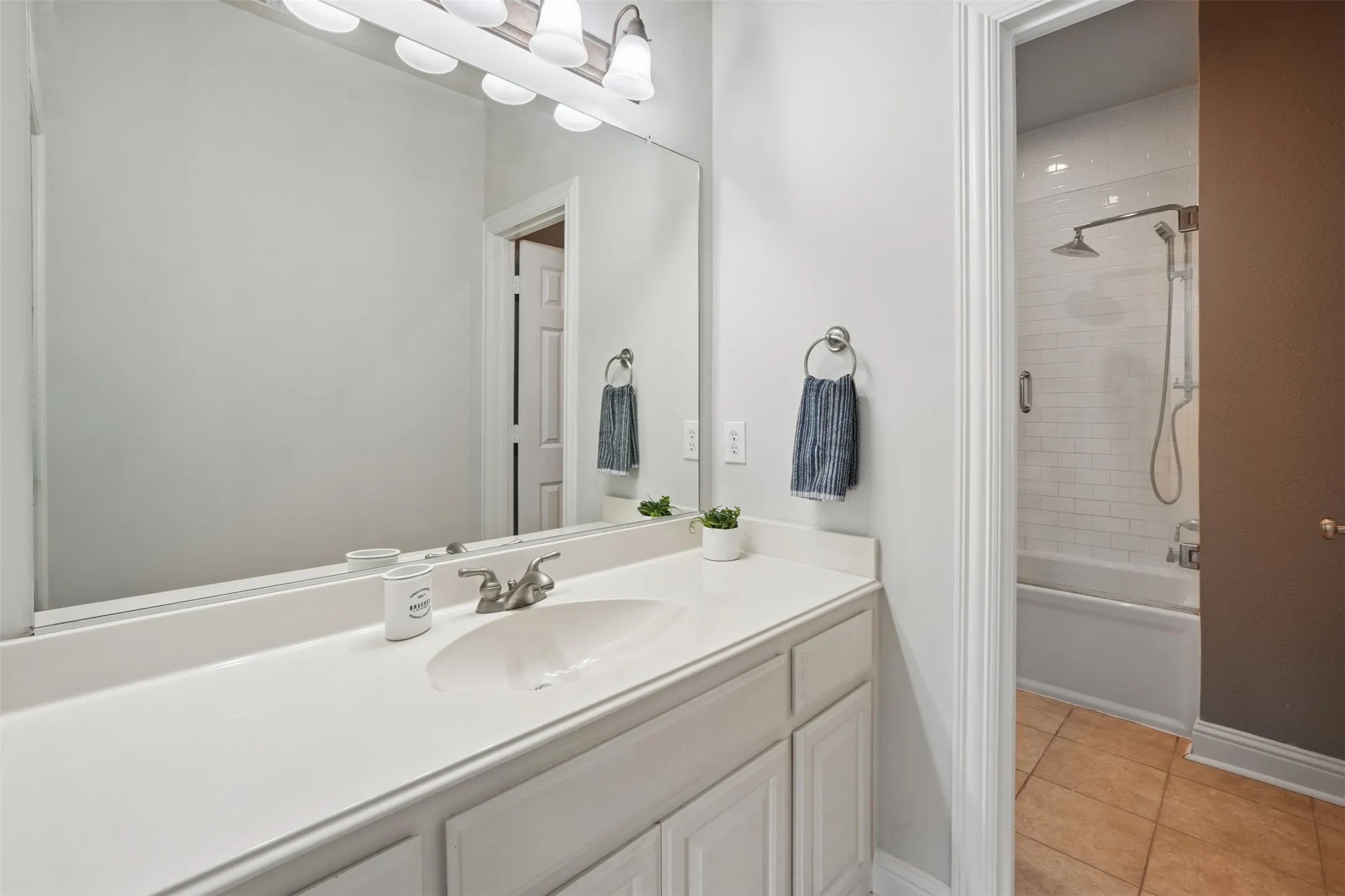 Jack-and-Jill bath connects secondary bedrooms while providing practical shared access.