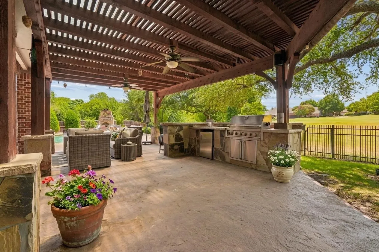 Large pergola includes a built-in outdoor kitchen and grill with abundant entertaining space, and a great view!