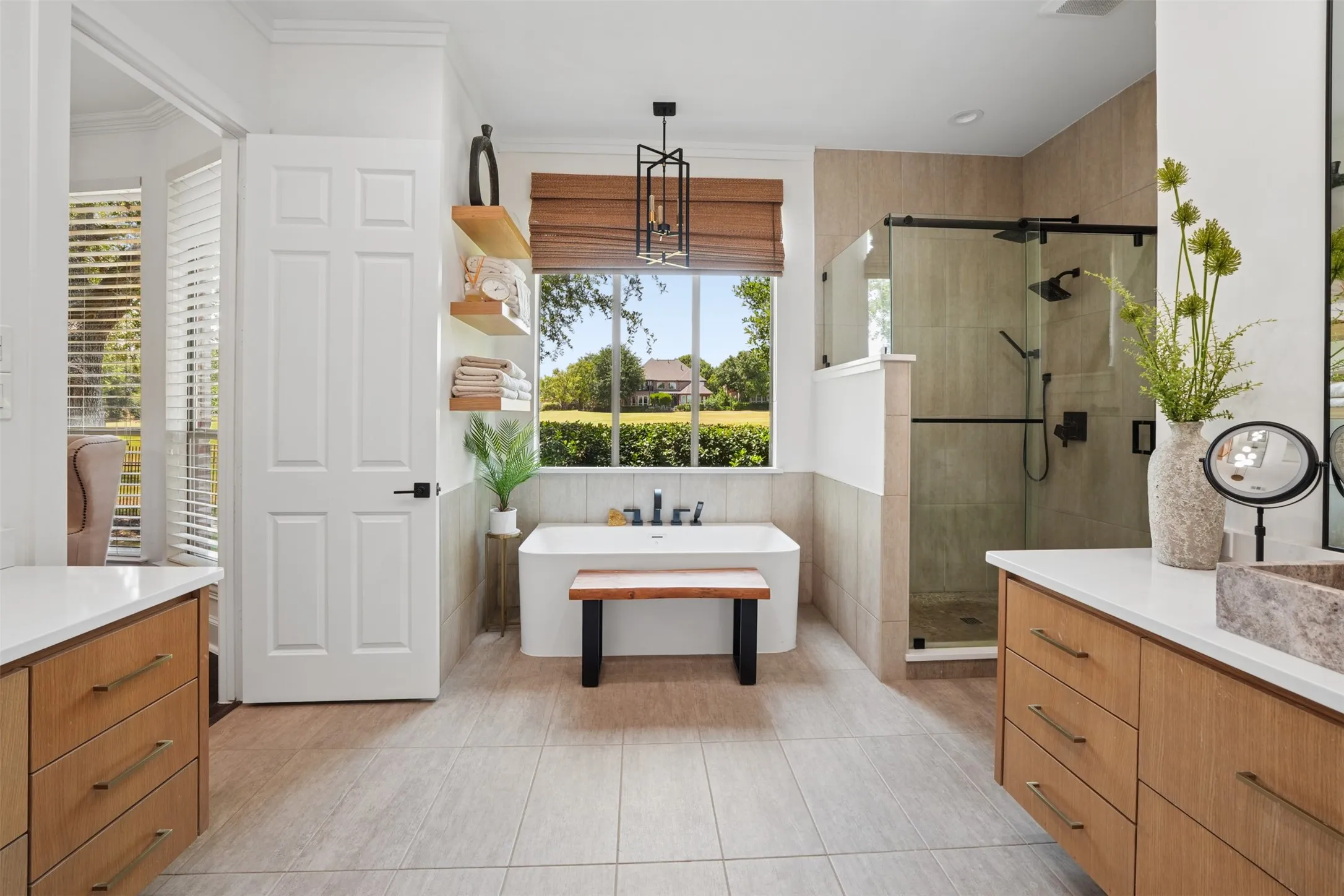 Updated primary bath features dual vanities, extensive cabinetry and abundant natural light.