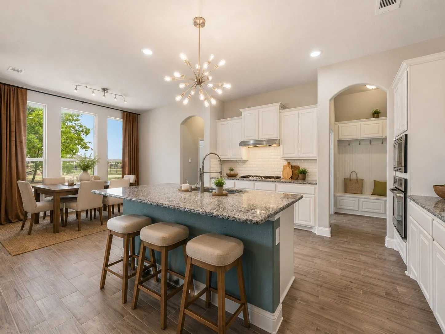Kitchen island featuring a granite countertop and sink with a gooseneck faucet