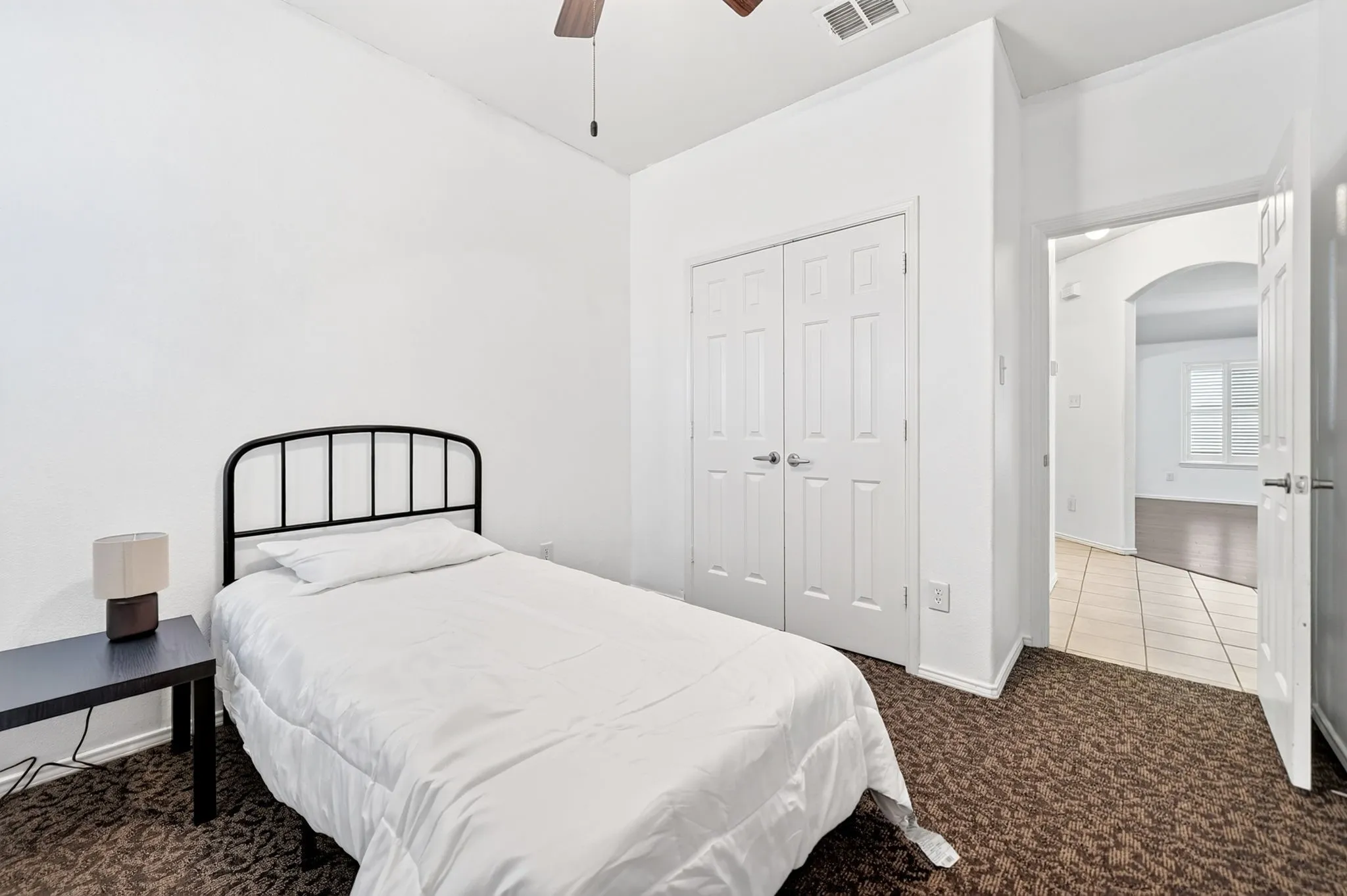 Carpeted room with double-door closet