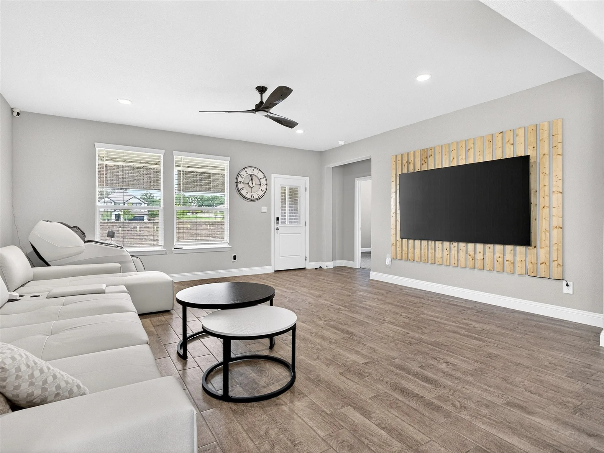 Wood-finish flooring throughout, recessed lighting, and a ceiling fan