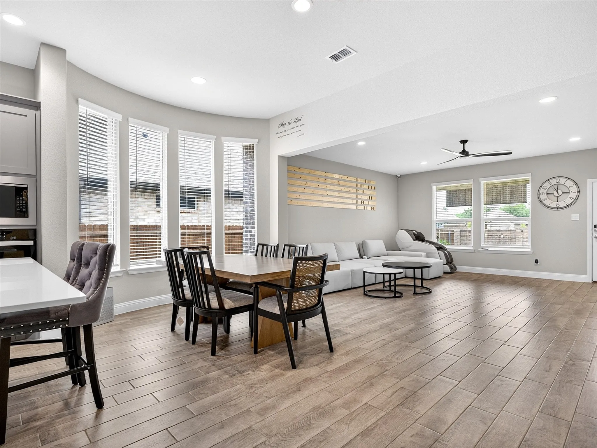 Open-concept living space featuring wood-finish flooring, recessed lighting, and a ceiling fan