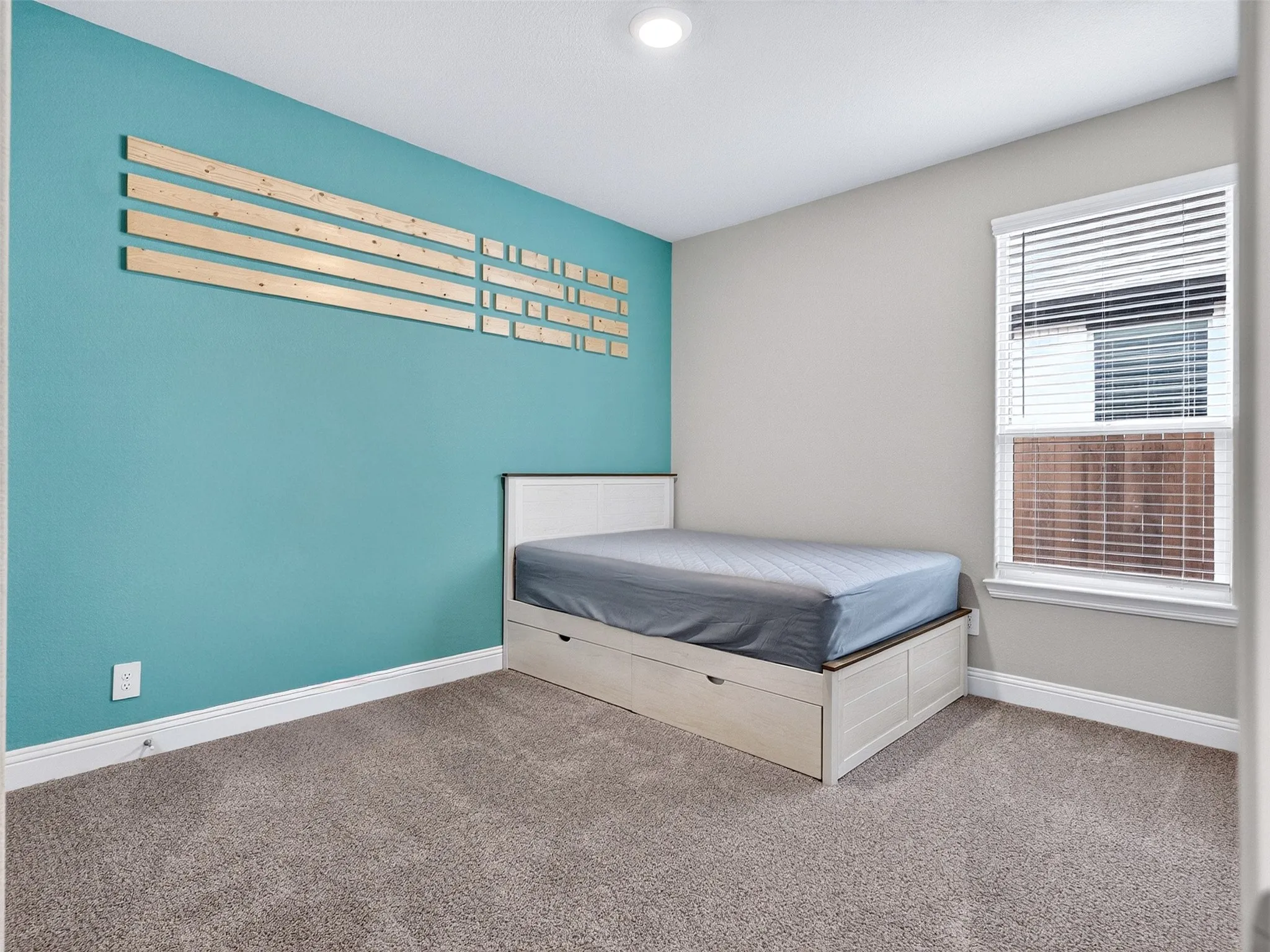 Plush carpet flooring, recessed ceiling lighting, and a window with blinds