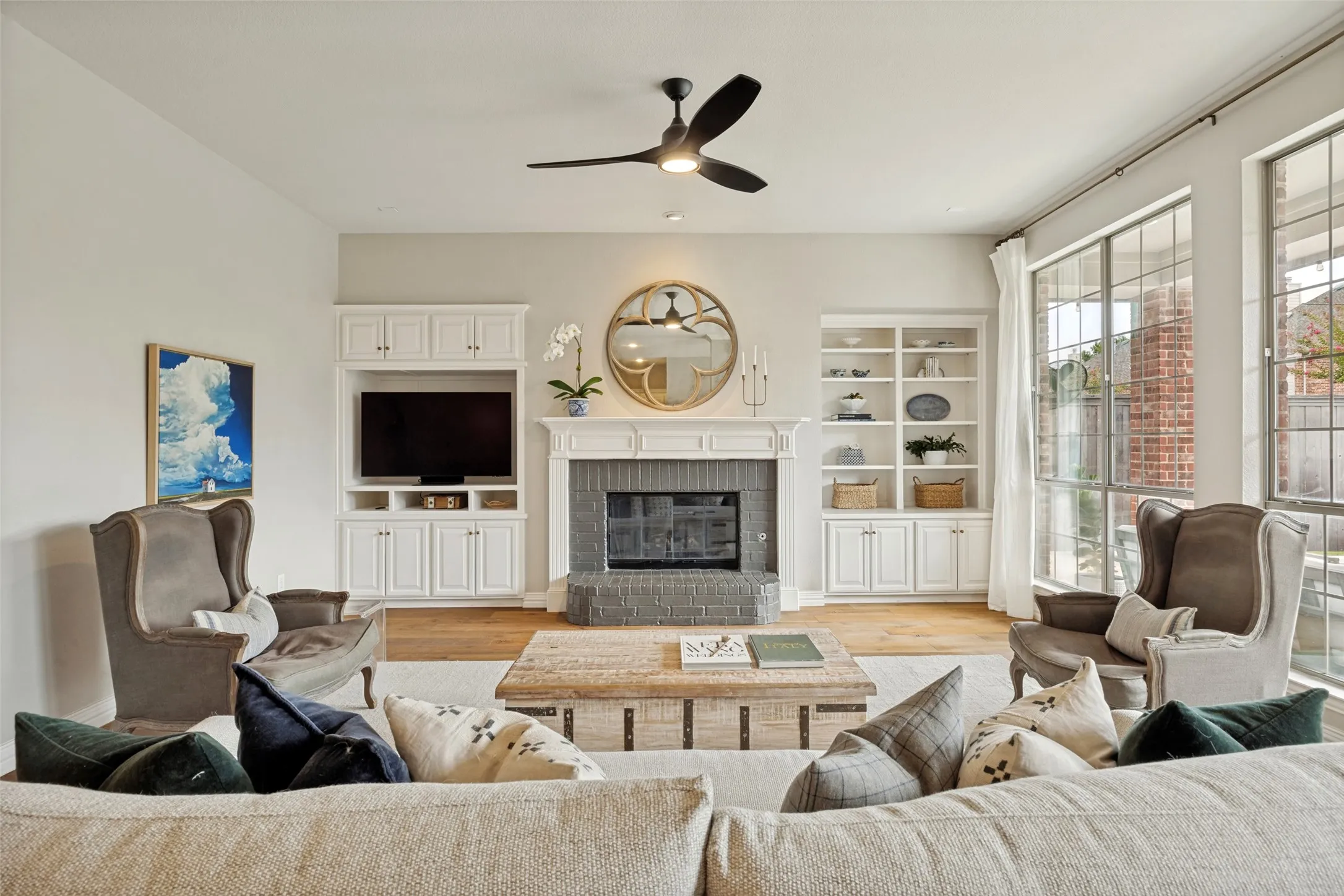Recessed lighting, wood-finish flooring, and a contemporary ceiling fan