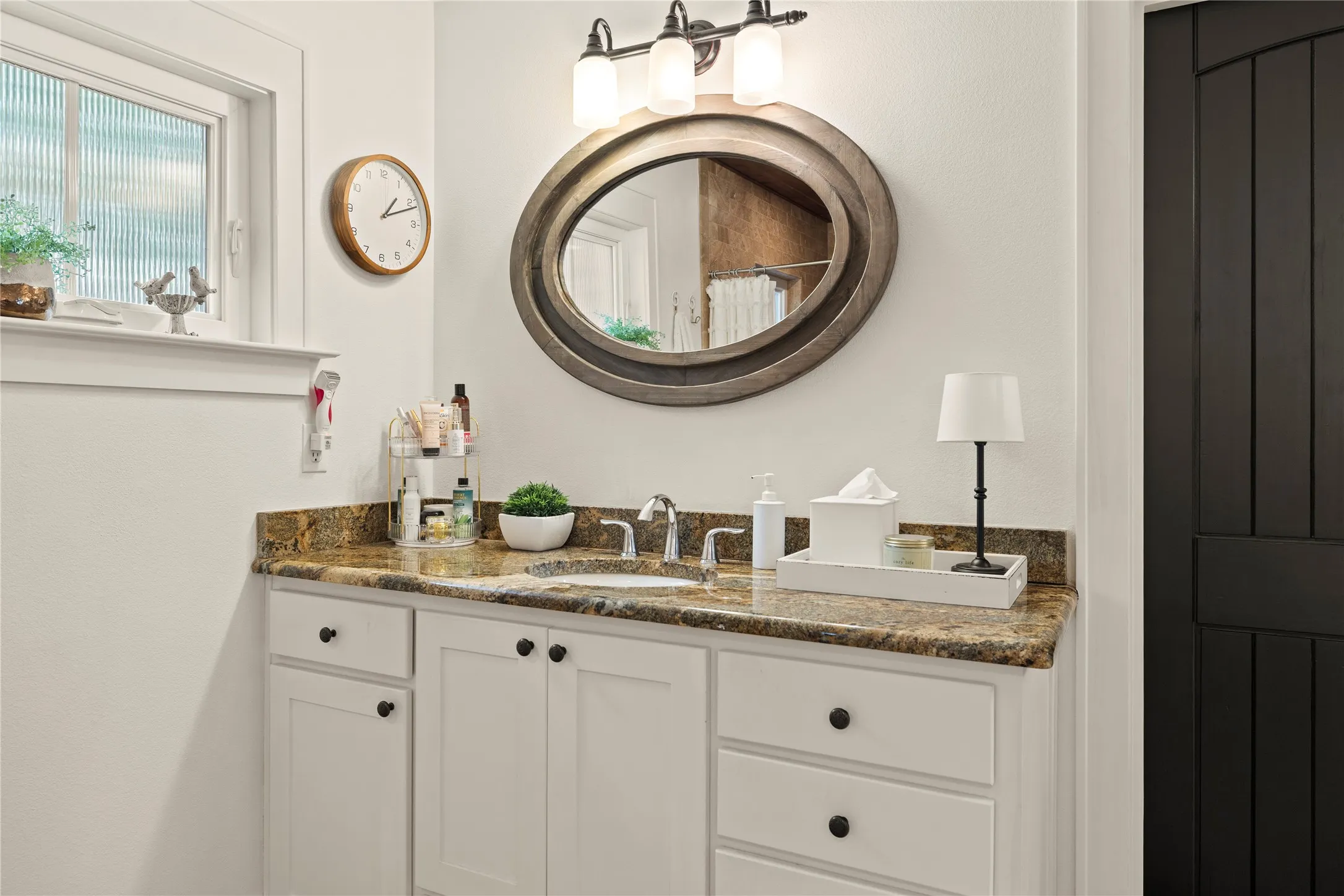 One of two dual vanities in the primary bath + a wide walk-in closet to the right.