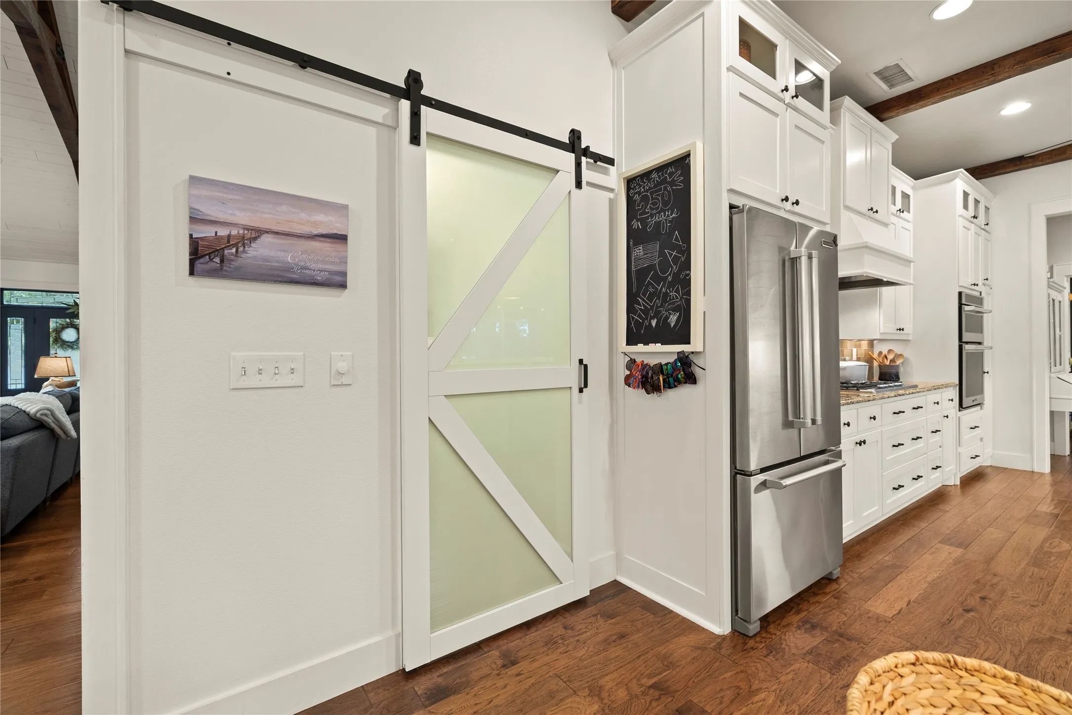 Tucked away inside the barn door----a combo walk-in pantry + washer-dryer utility room.