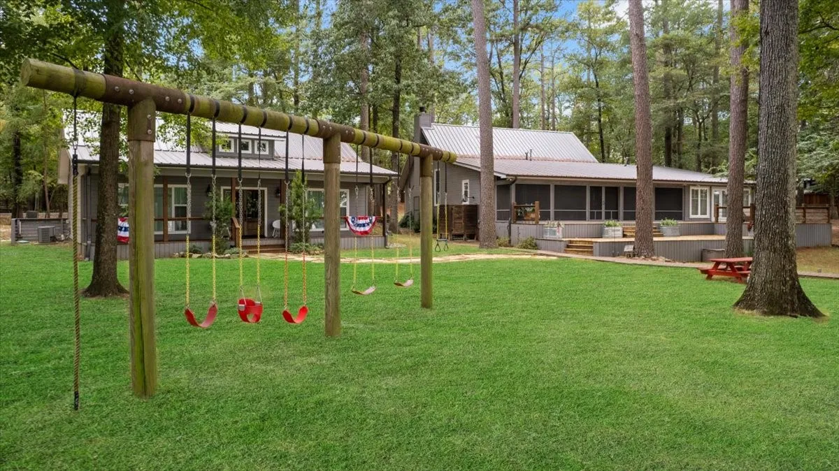 A spectacular double-lot setting creates an expansive backyard retreat, perfectly positioned to capture stunning panoramic lake views. Kids will love the custom playset & full sod backyard the sellers added.