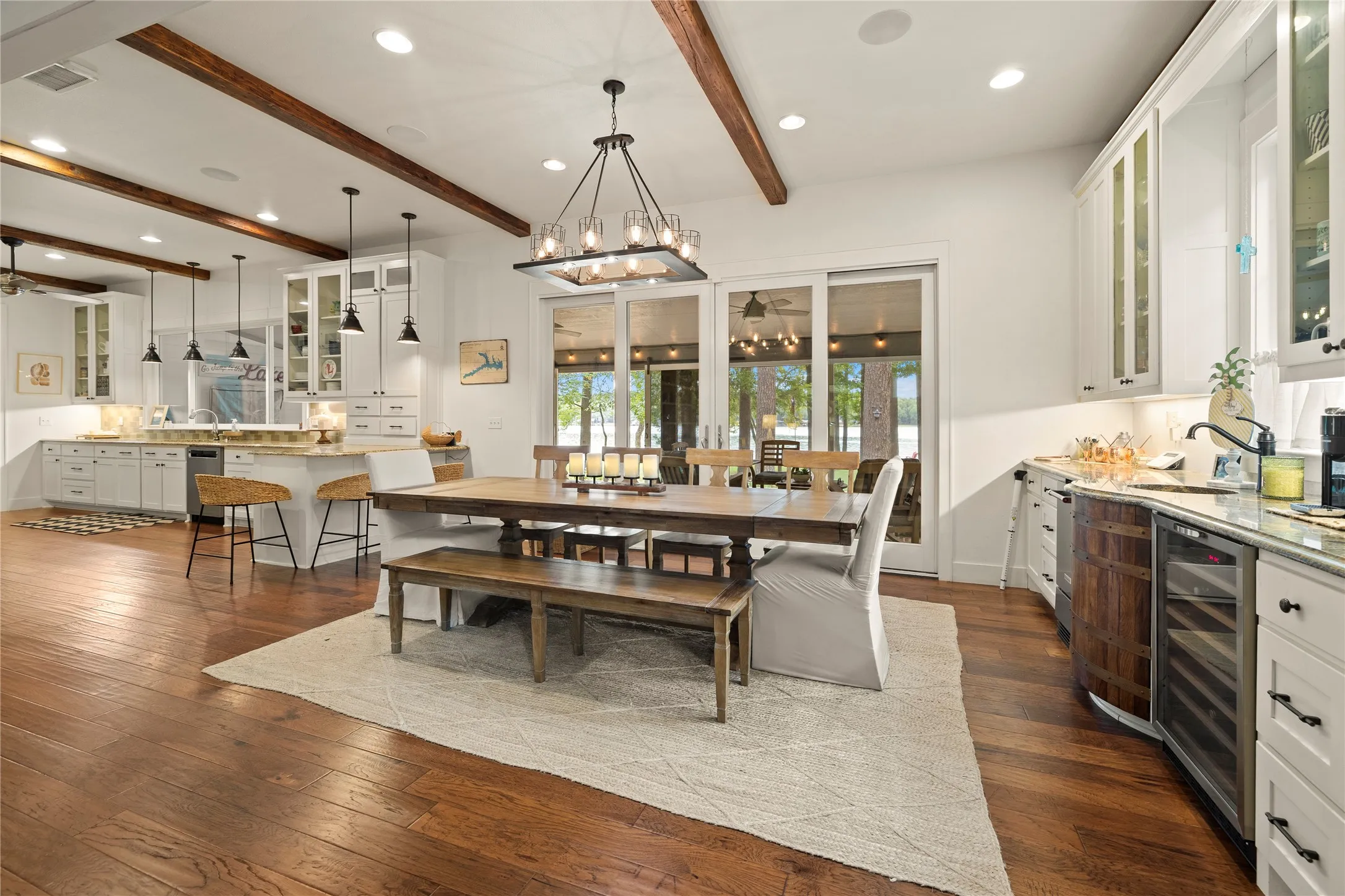 The striking, open dining space is perfectly positioned between a large wet bar with a wine refrigerator on one side + a generously sized kitchen on the other ~ creating an exceptional setting for entertaining & family gatherings.