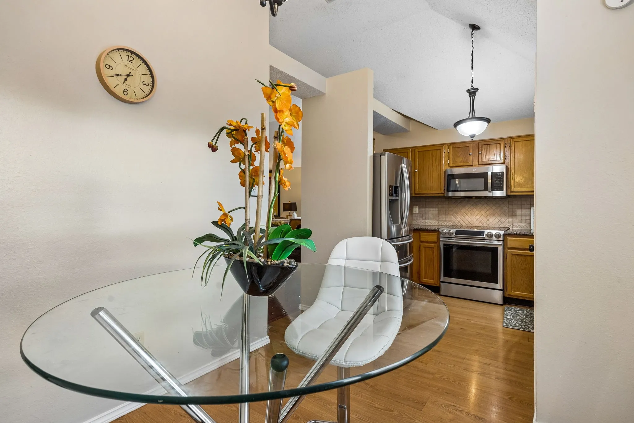 Kitchen featuring wood-finish cabinetry, stainless steel appliances, and a tiled backsplash