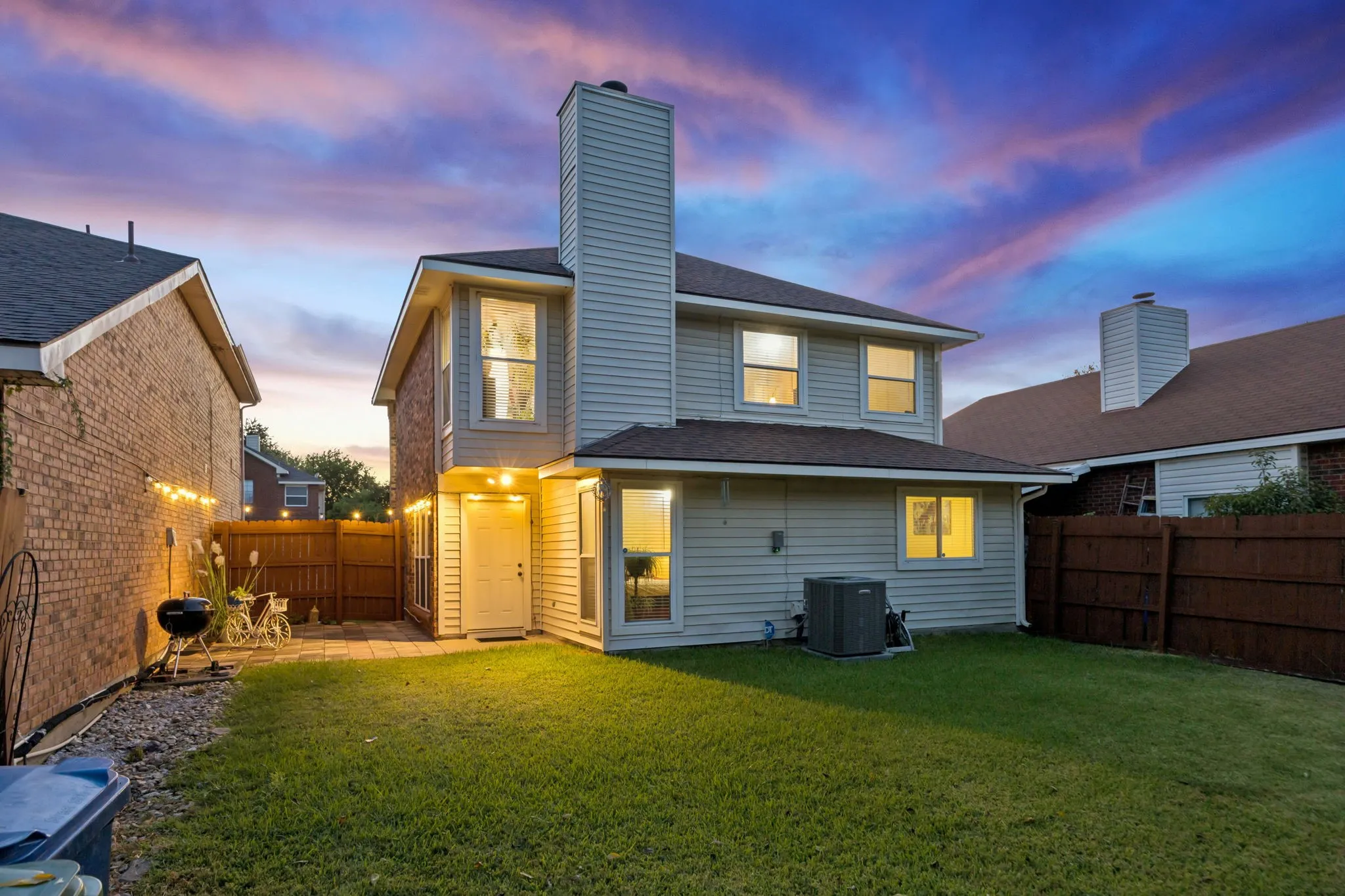 Expansive green lawn with a patio area