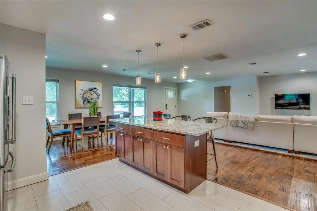 Kitchen island with granite countertop and pendant lighting