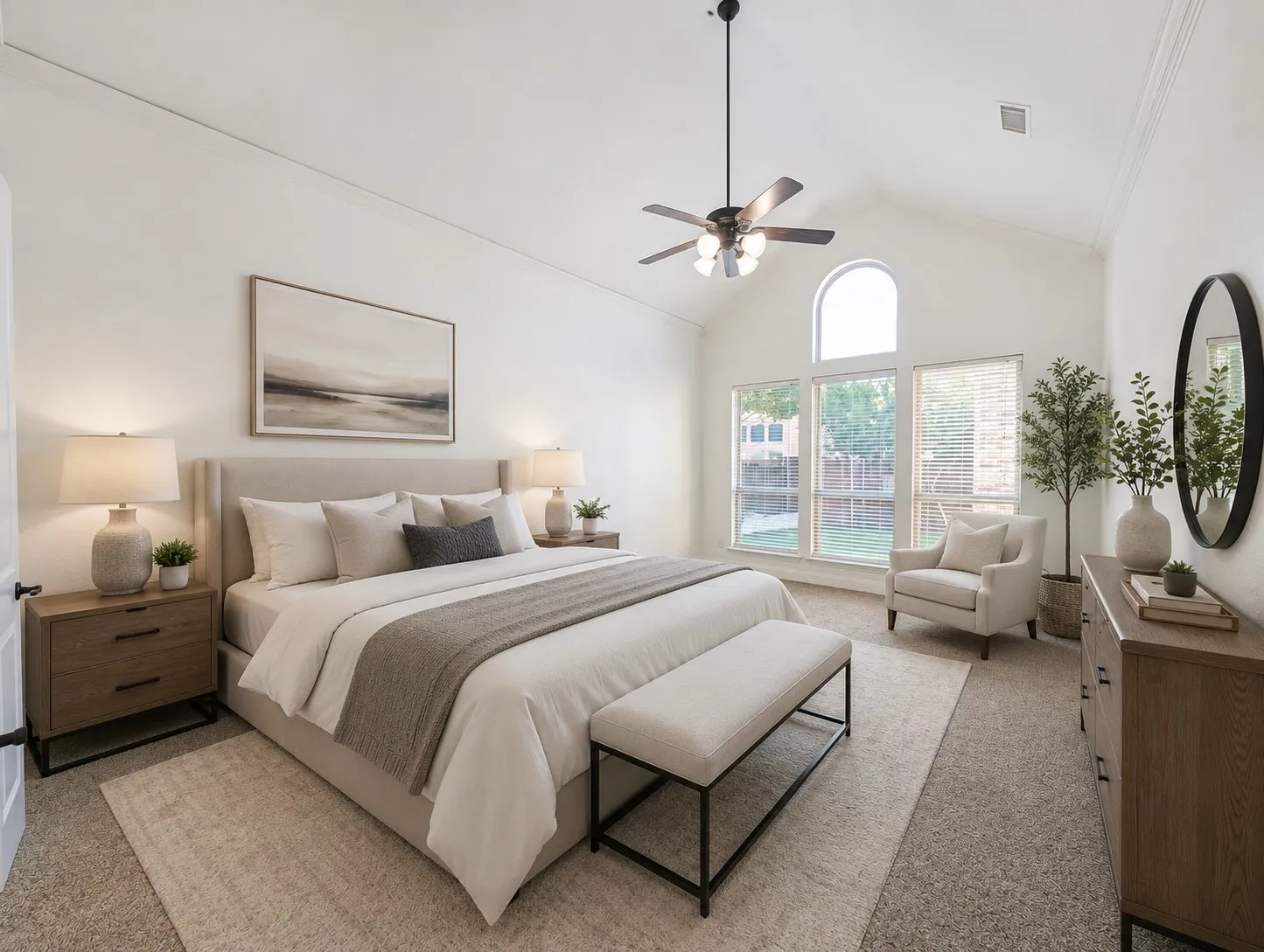 Vaulted ceiling with an arched window, large picture windows, paddle fan light fixture, and crown molding