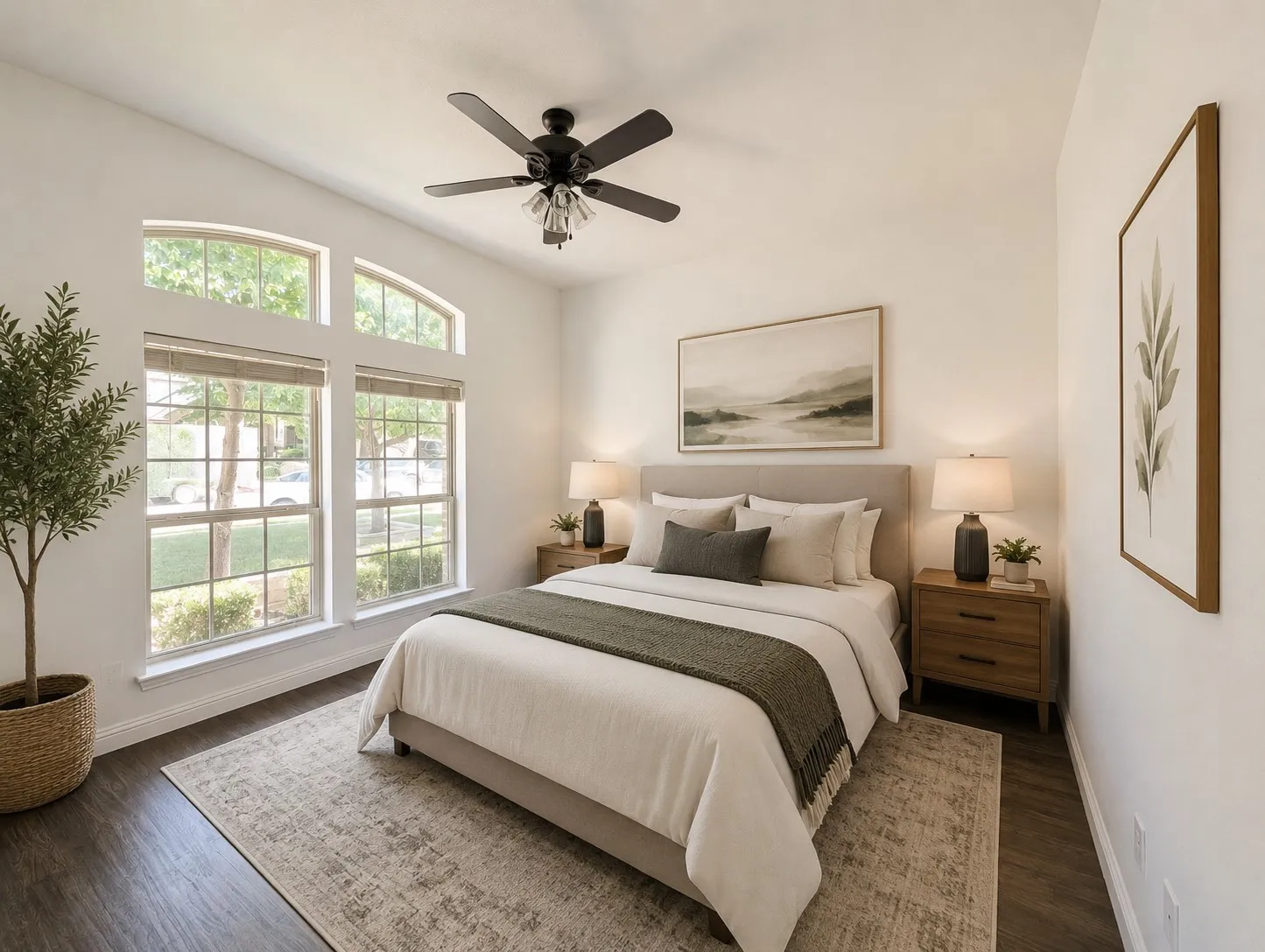 Soaring vaulted ceiling, wood-finish flooring, architectural windows, and a ceiling fan with integrated lighting
