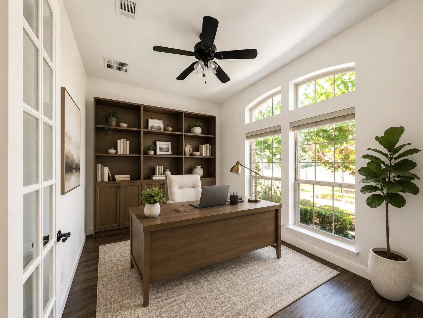 French doors, built-in shelving, vaulted ceiling, large windows with arched transoms, wood-finish flooring