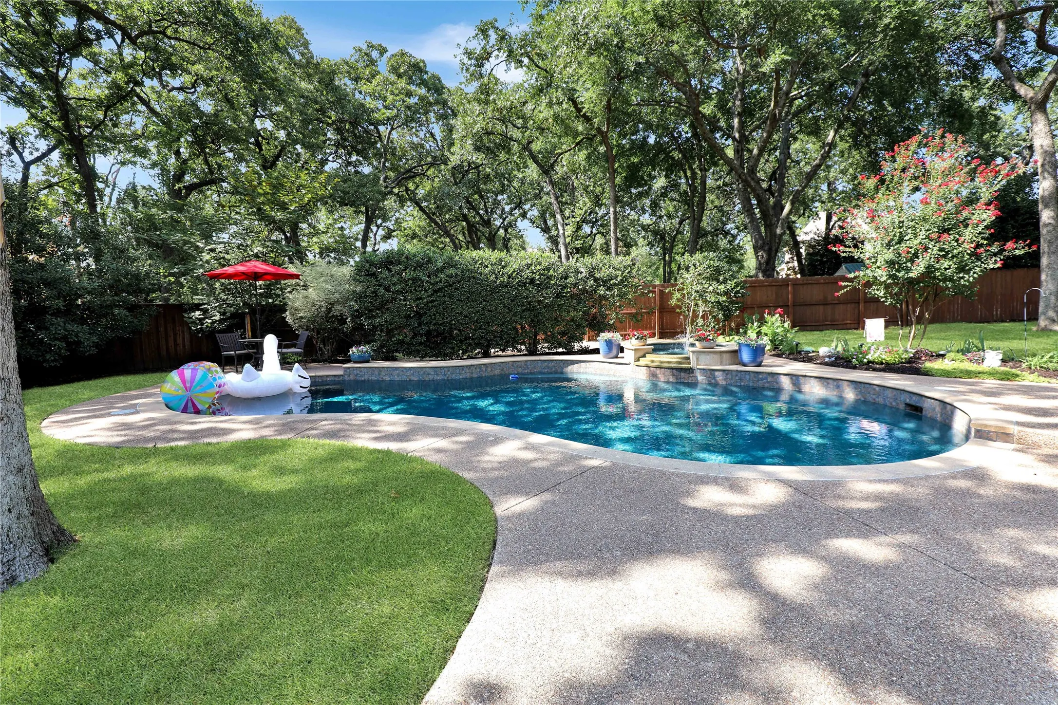 View of pool and spa water feature from patio