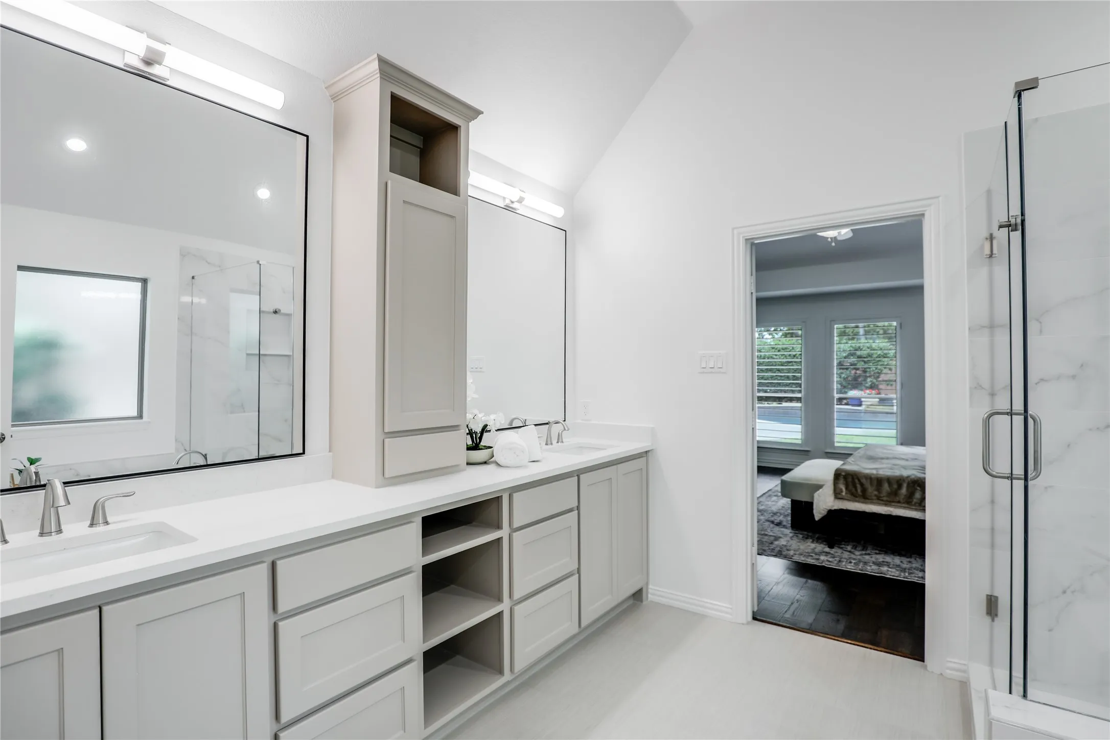Dual vanities with separate sinks, cabinet for linens and medicine