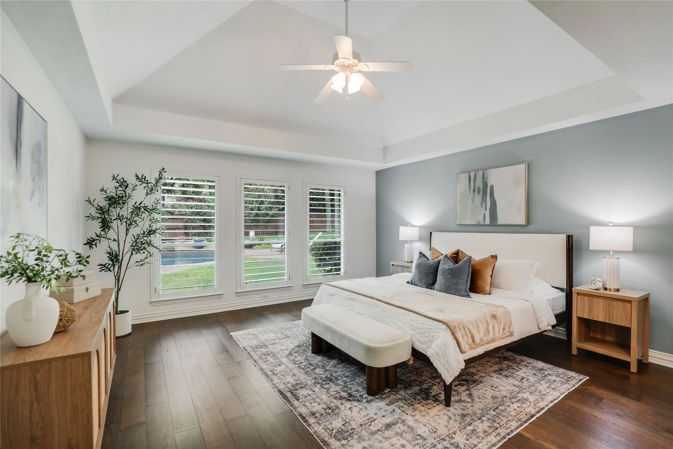 Primary bedroom with view of pool and spa