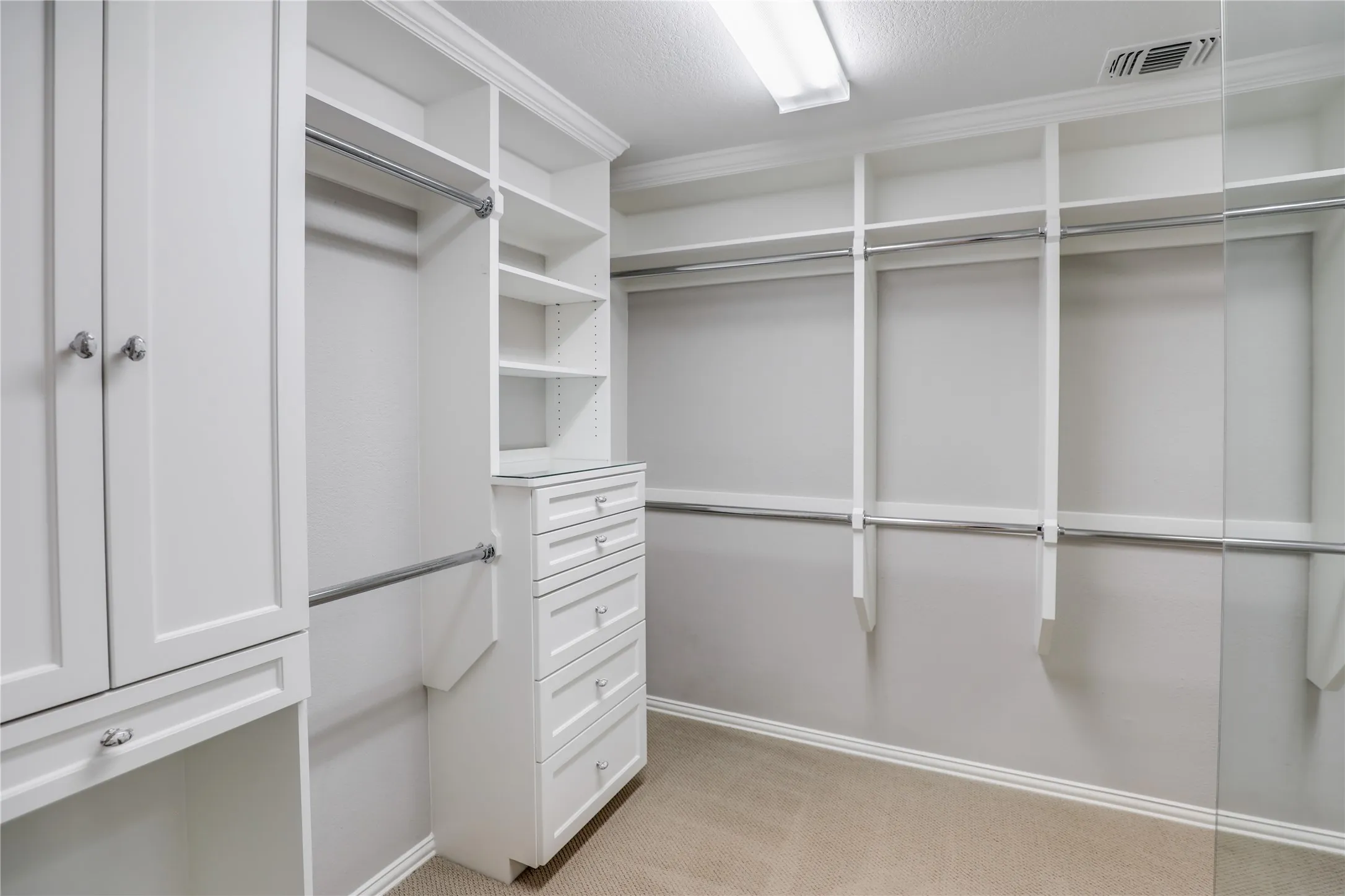 Large custom closet with separate dressing areas