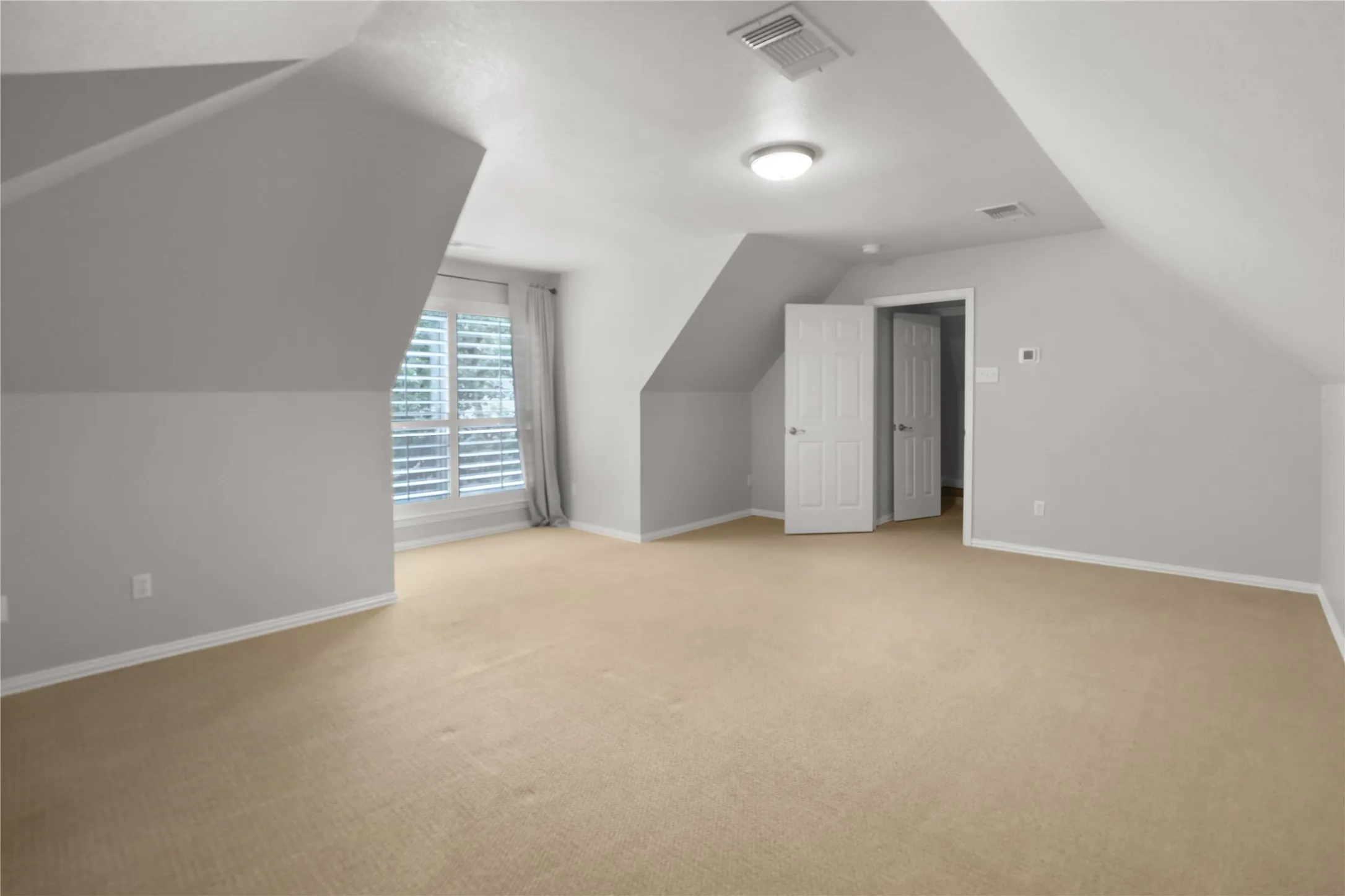 Large bonus room above garage with window and closet