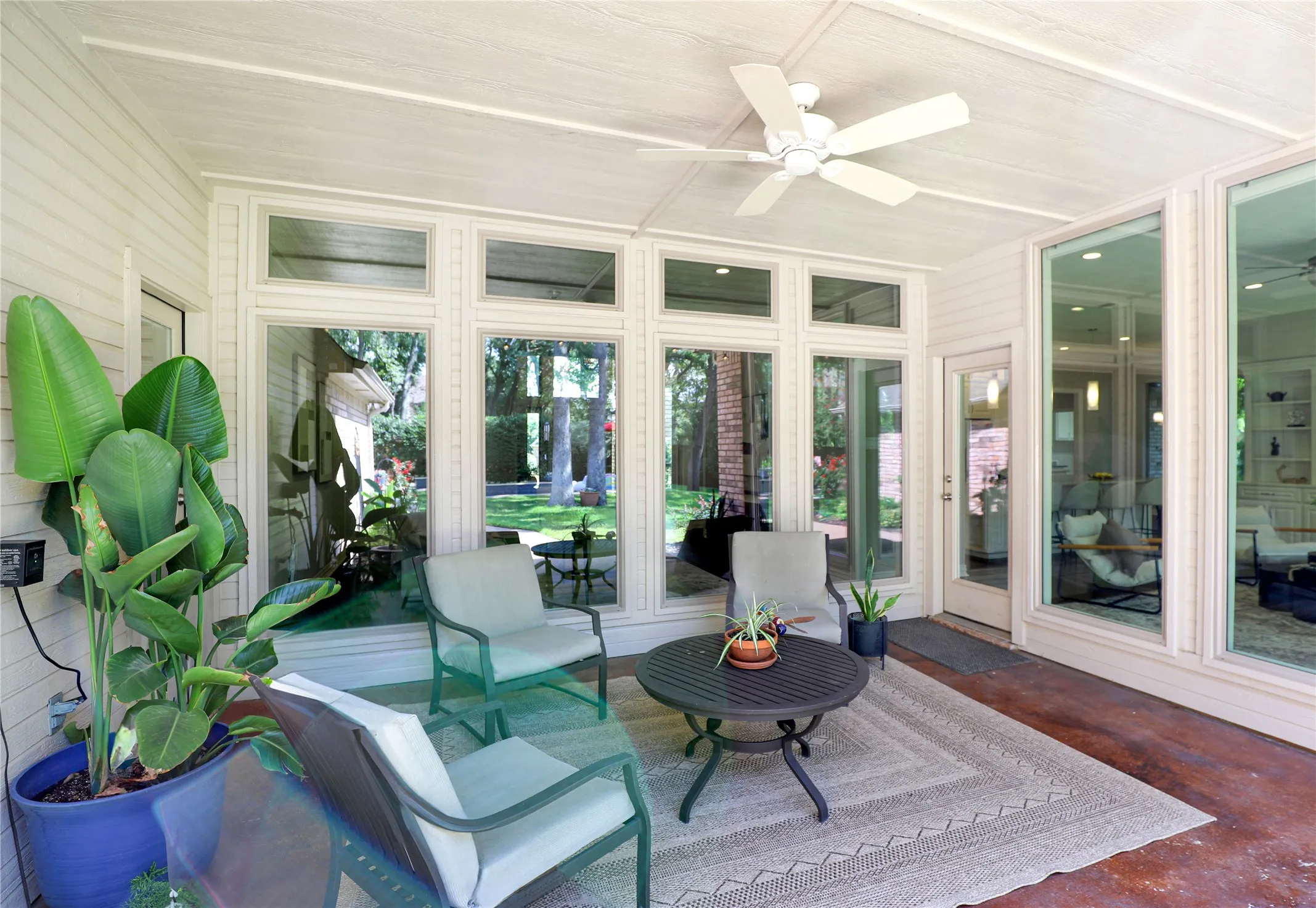 Living room surrounded by tall windows and natural light