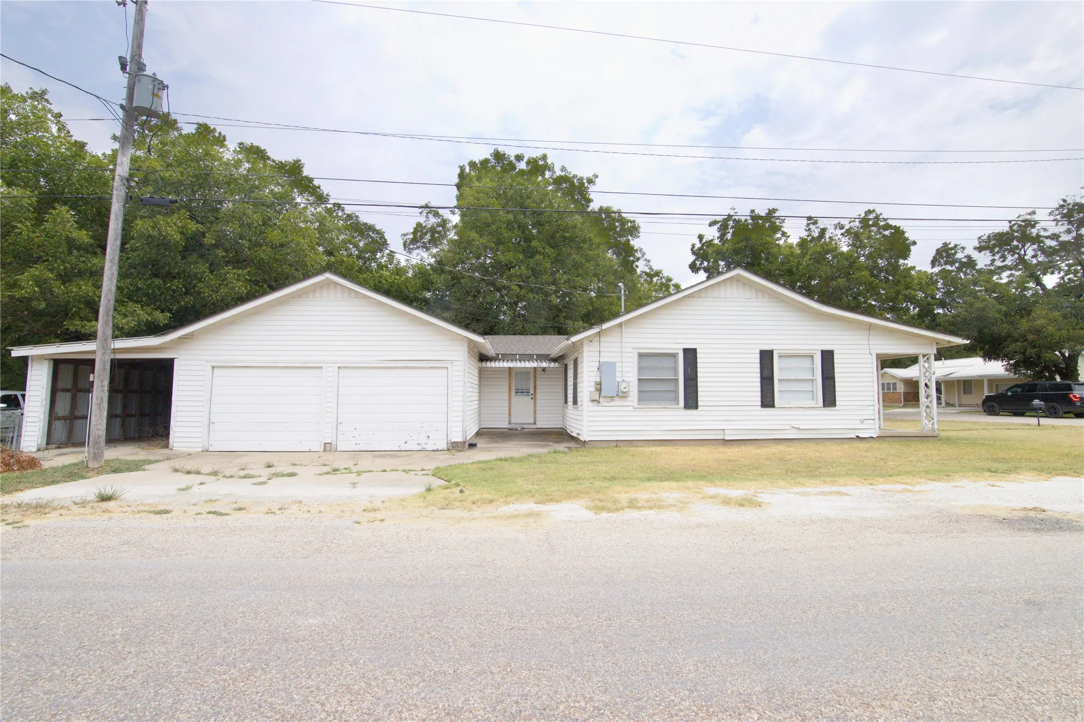 White siding exterior with a pitched roof