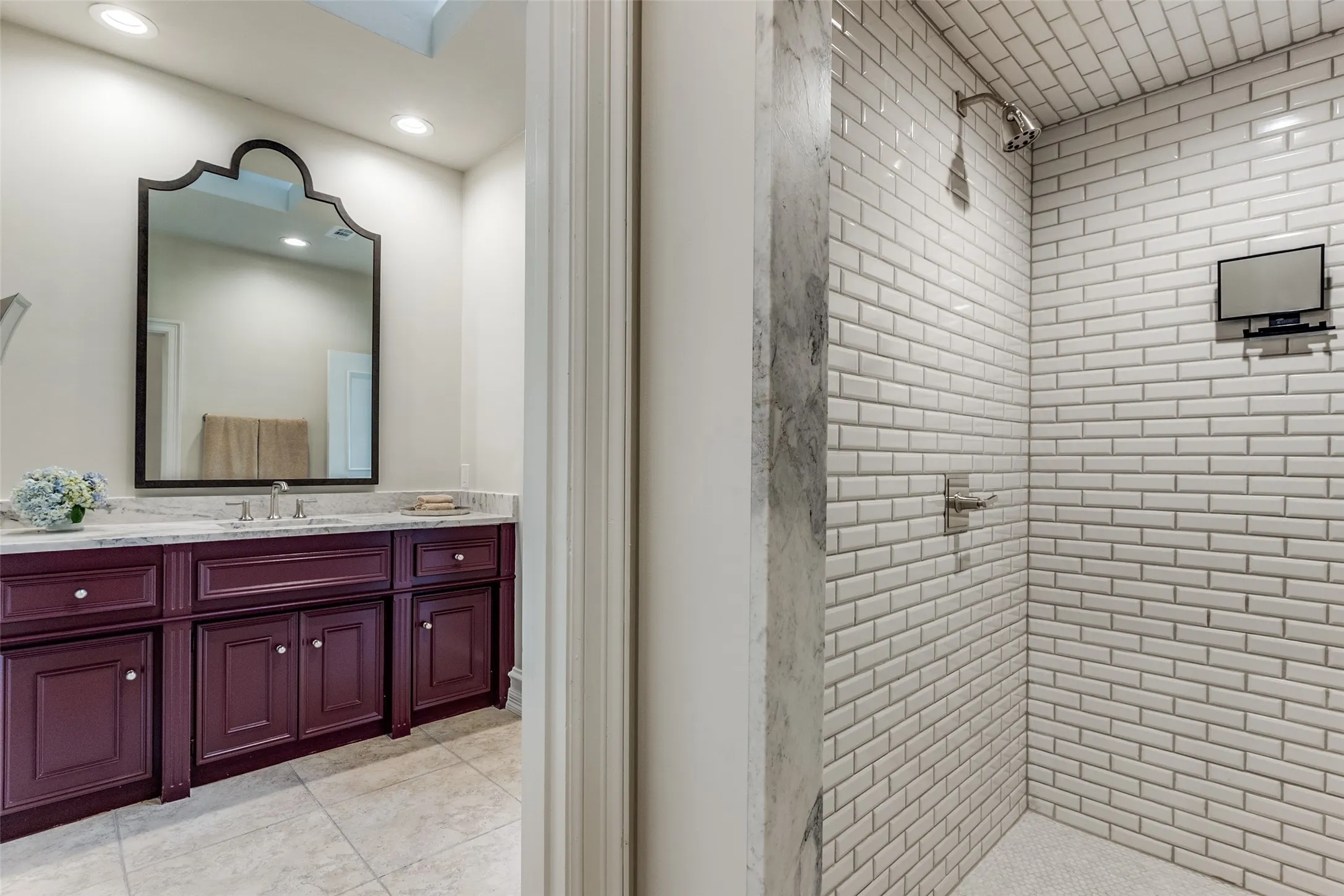 The 2nd primary en-suite bathroom with decorative mirror, tiled shower, toilet room and spacious walk in closet.