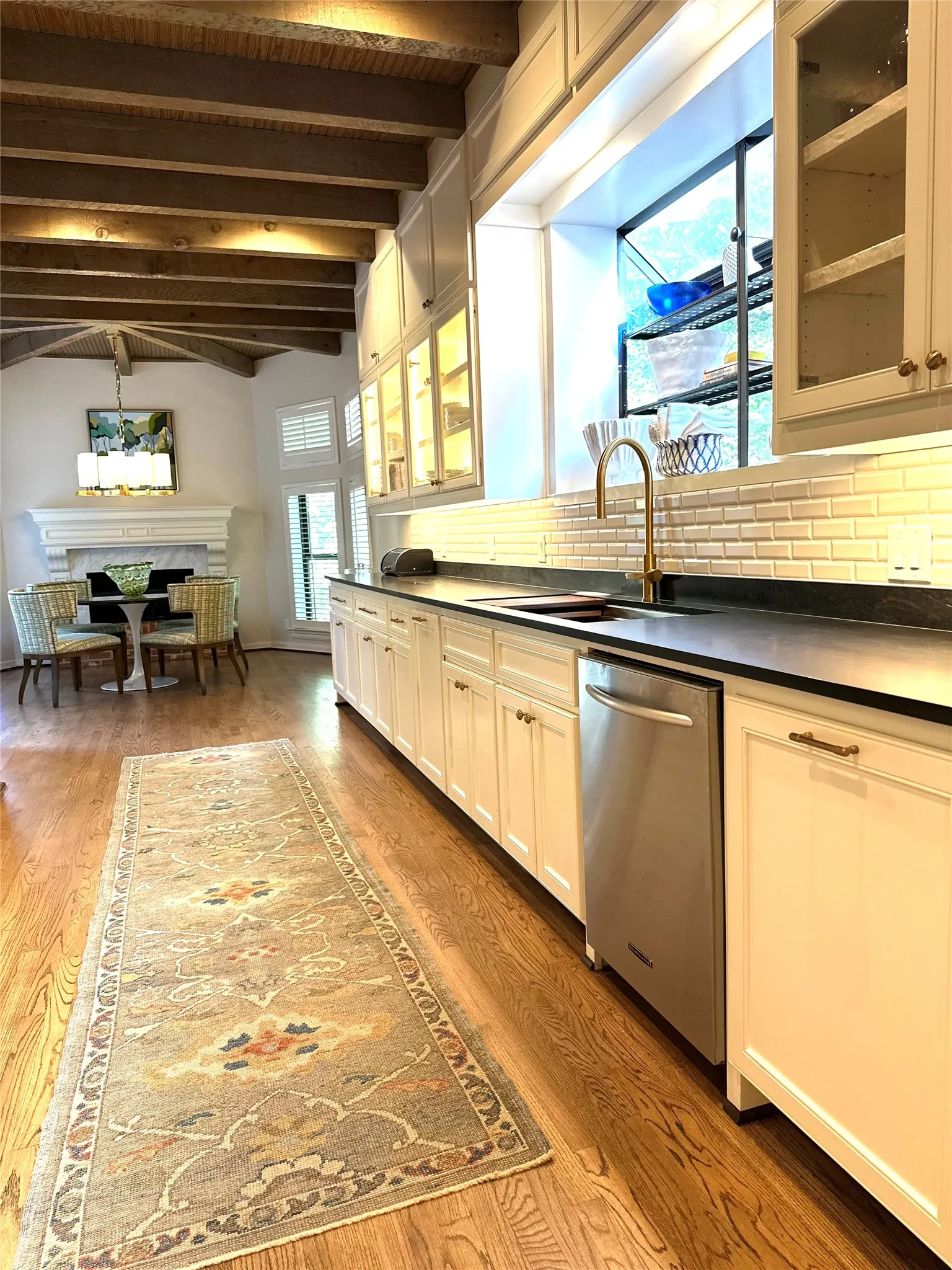 Recently renovated kitchen with gas range top, wall ovens, soft close drawers, and velvet granite countertops