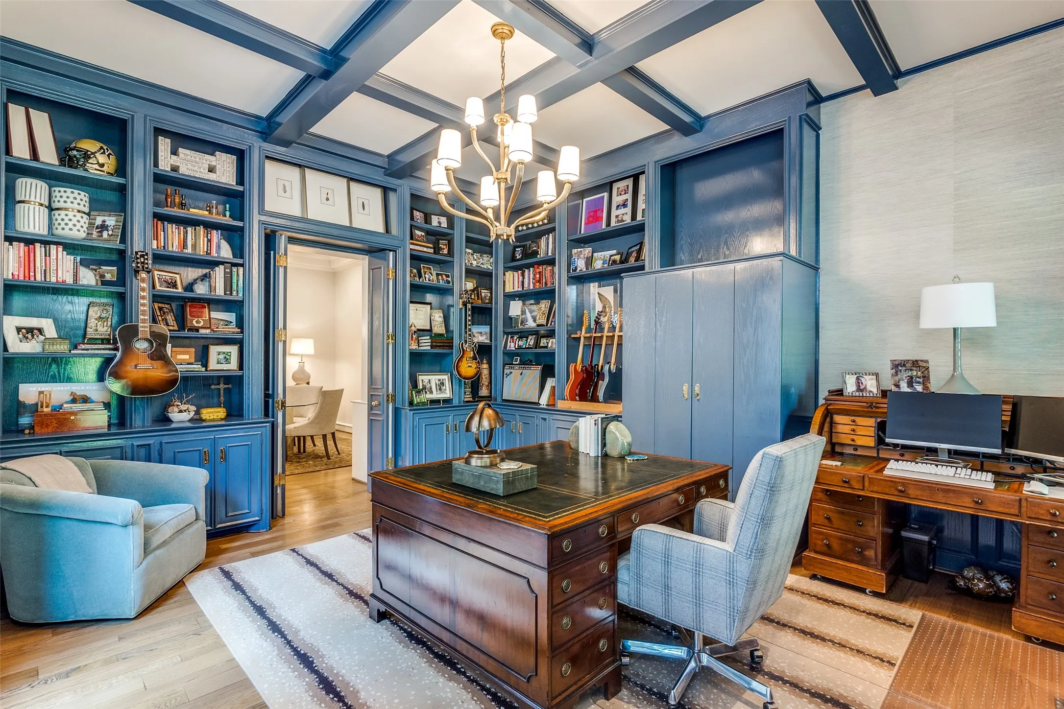 Transitional study blends warmth with modern polish through unique lighting and space to work and relax
