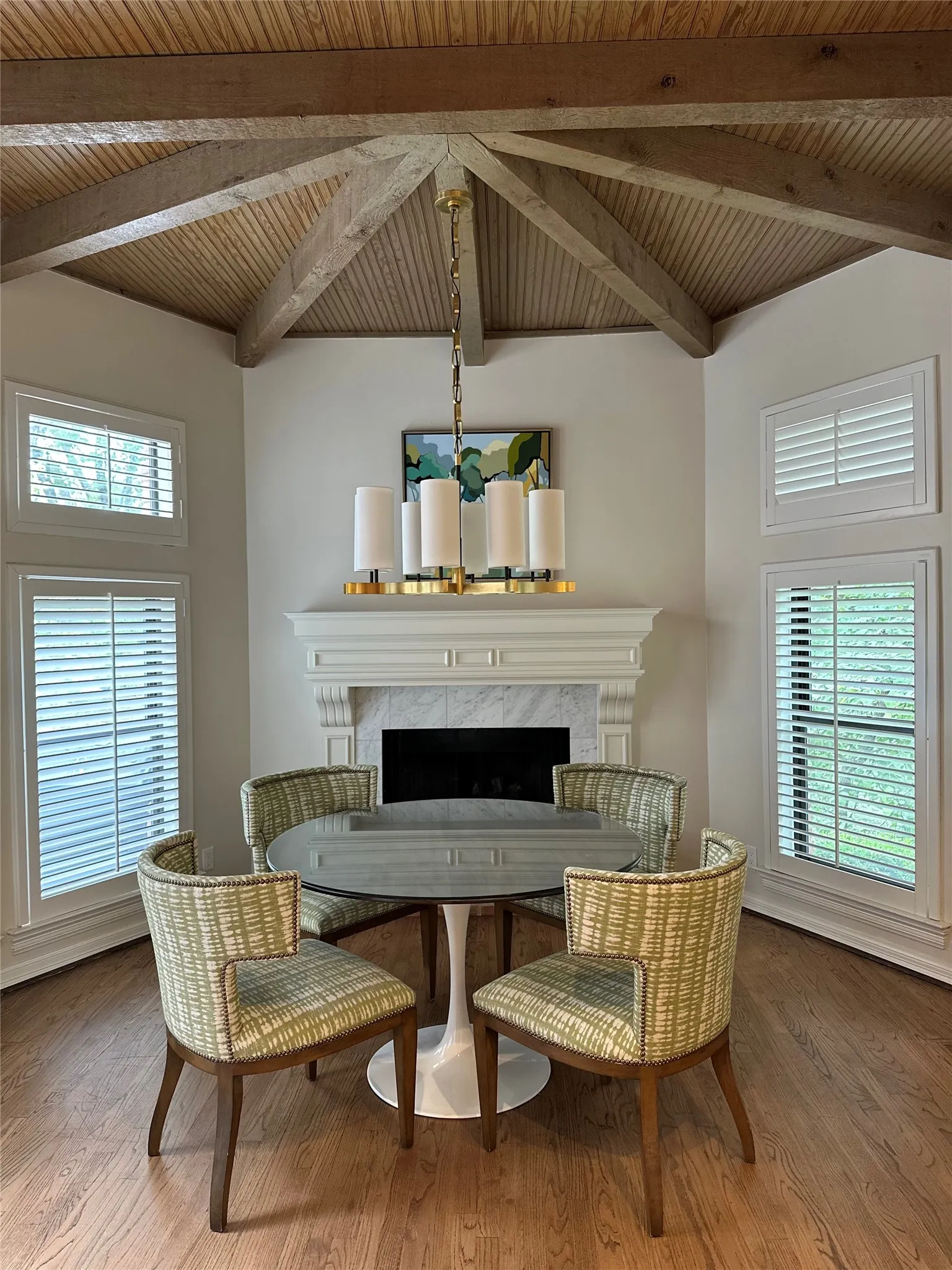 Inviting Breakfast room area with cozy, marbled fireplace and creek views