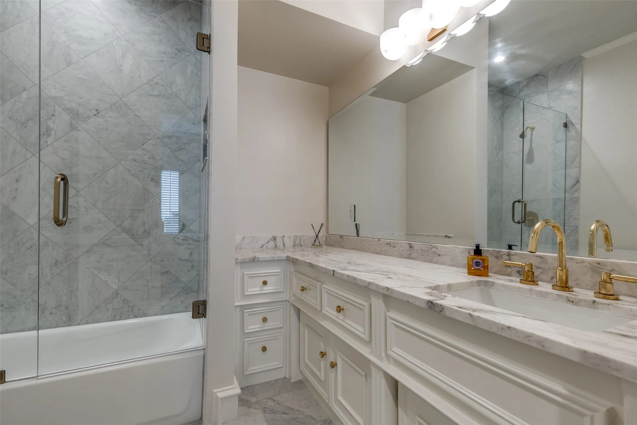 En-suite bathroom for Bedroom 4 with marble tops and shower tiles, along with new plumbing fixtures.