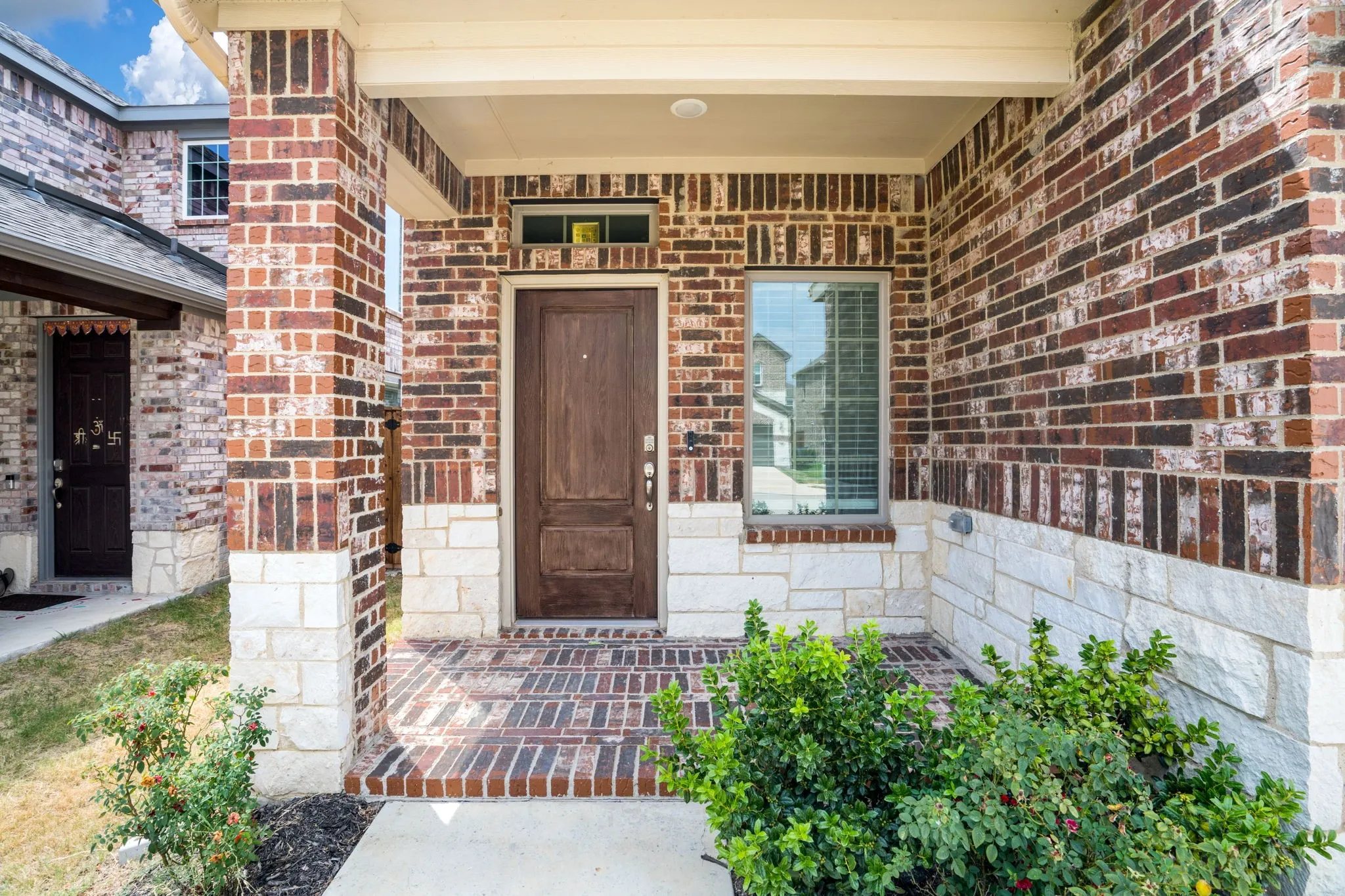 Brick and stone facade with a covered entry
