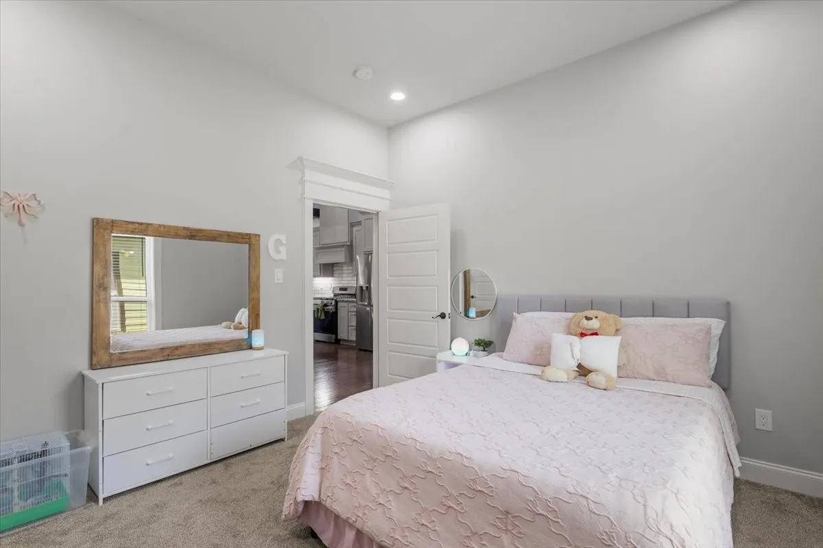 Recessed ceiling lighting, light gray wall color, carpet flooring, crown molding, and white trim