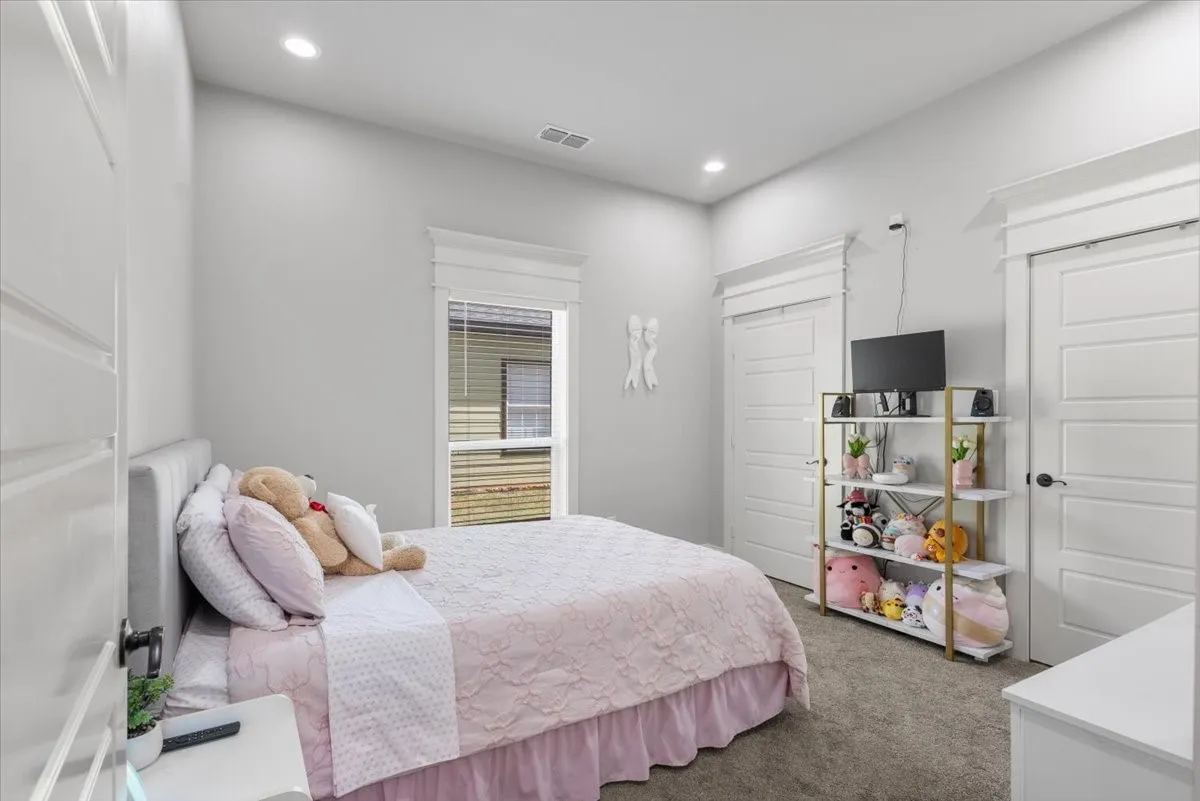 Recessed lighting, light gray wall finish, window with white blinds, five-panel interior doors, and gray carpet flooring