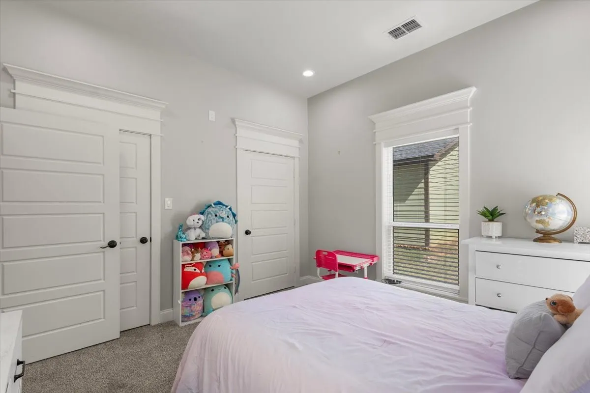 Recessed lighting, light-toned walls, and paneled interior doors