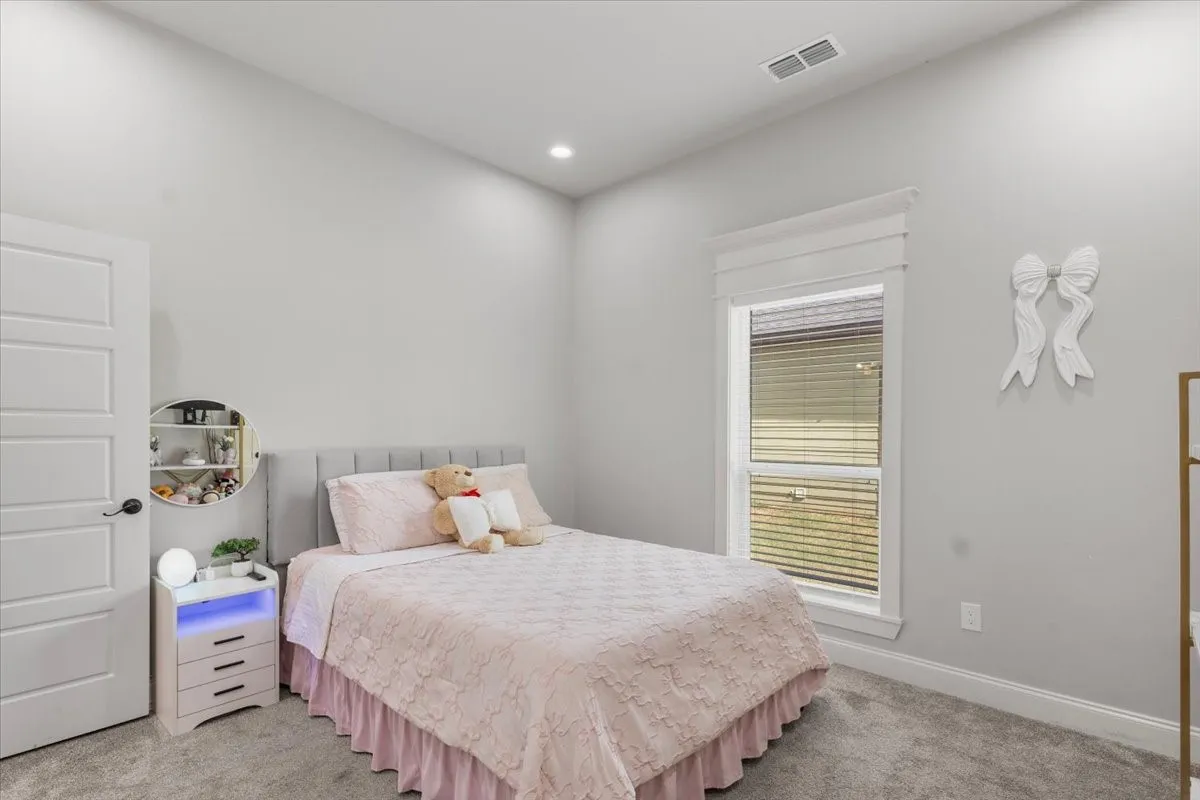 Recessed lighting, window with blinds, paneled interior door, and grey carpet