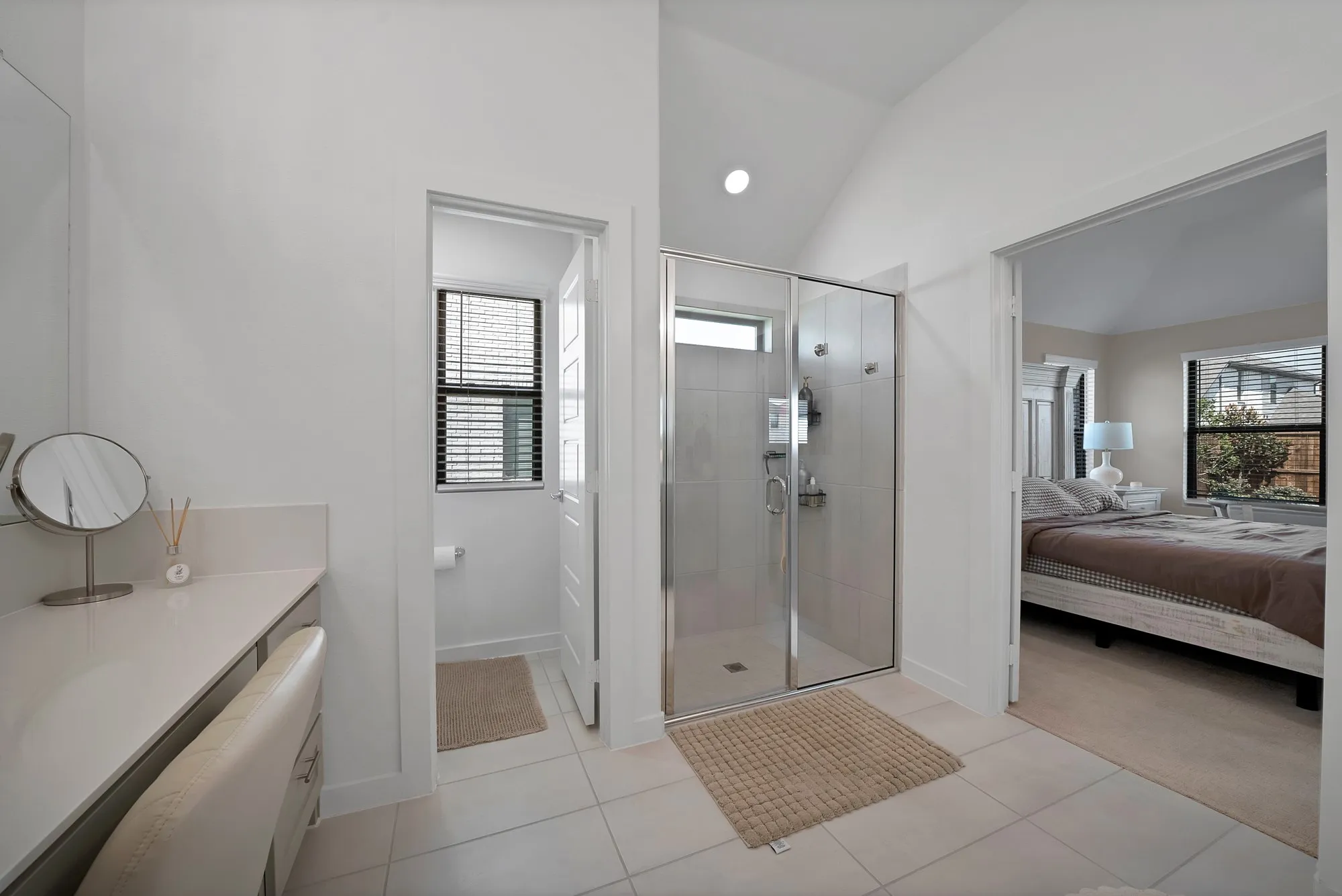 Vaulted ceilings carry through into the primary bathroom.