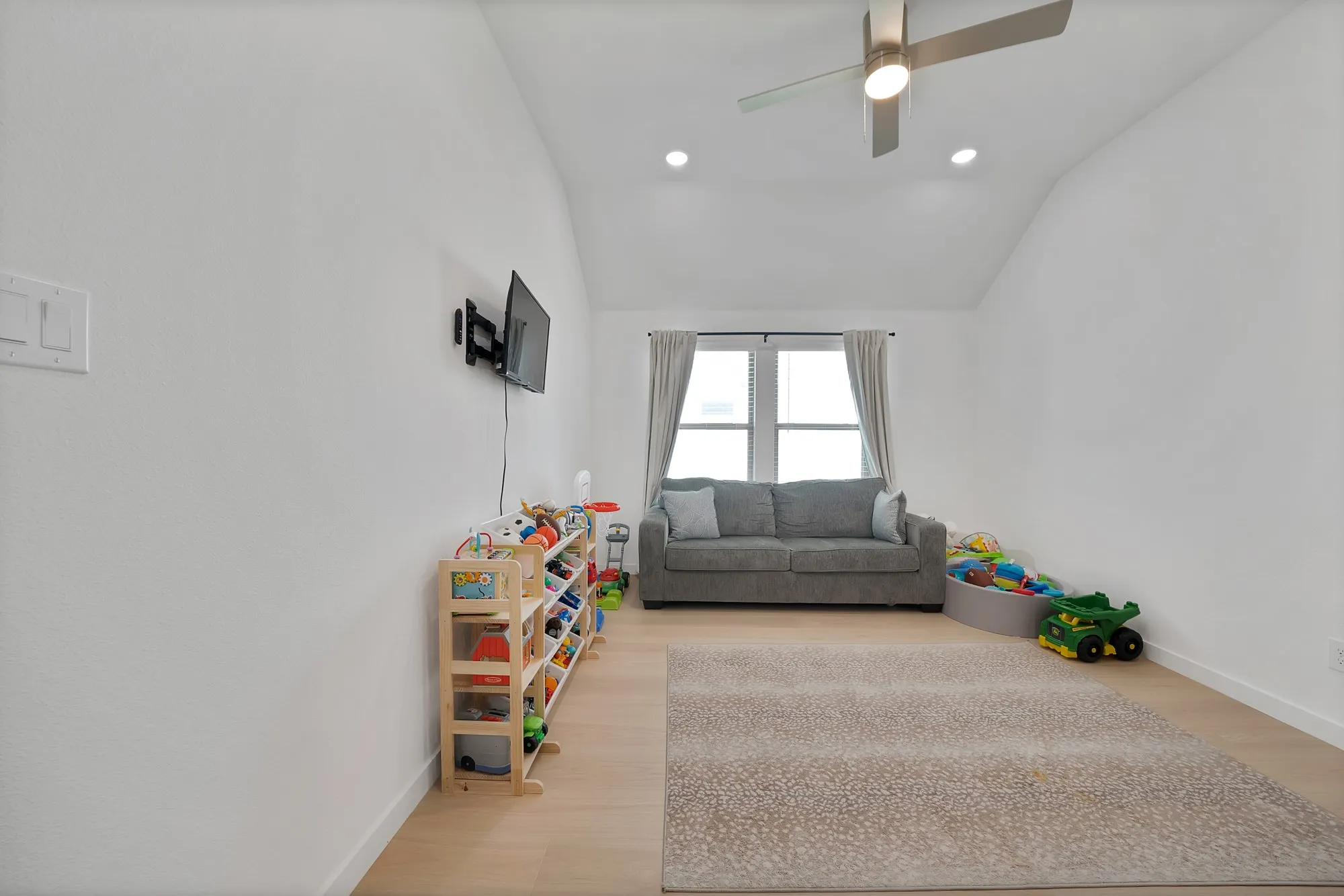 This spacious game room is currently being used as a children's play retreat.
