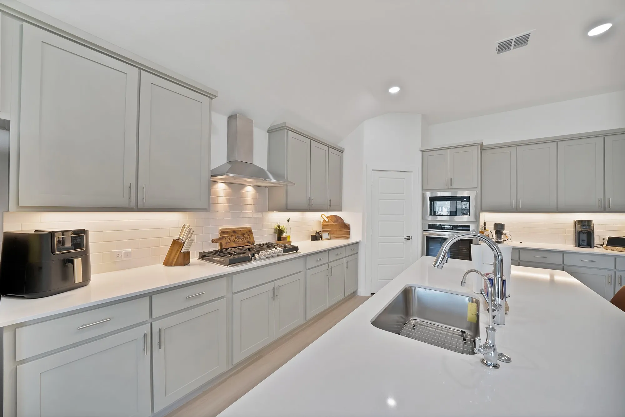 Stainless steel appliances with a beautiful backsplash keeping this kitchen sleek.
