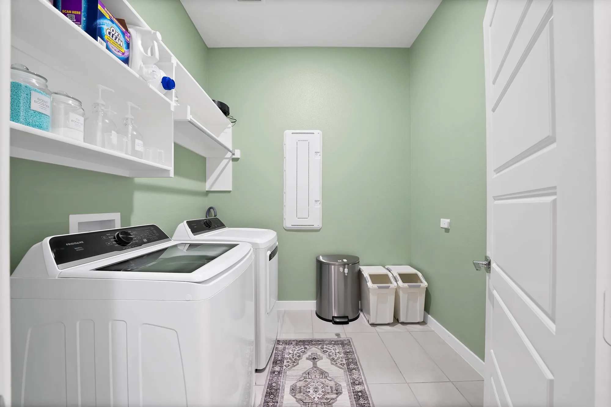 Laundry room with W/D hook ups, shelves and a drying rack.
