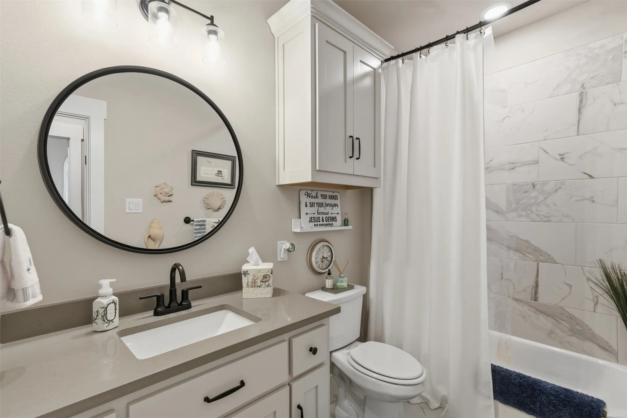 White cabinetry, integrated sink, and gray countertop