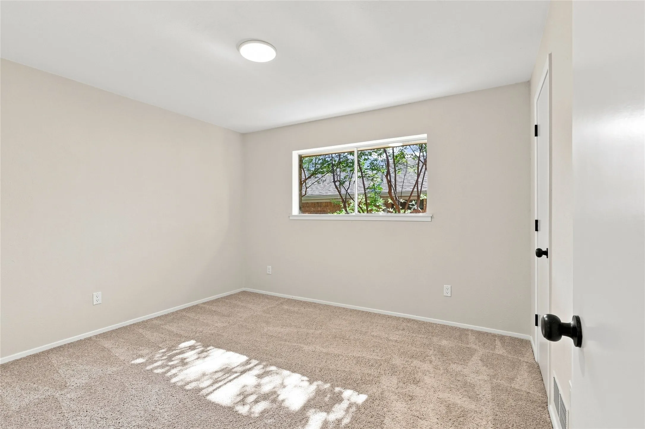 Neutral-toned walls with plush carpeting