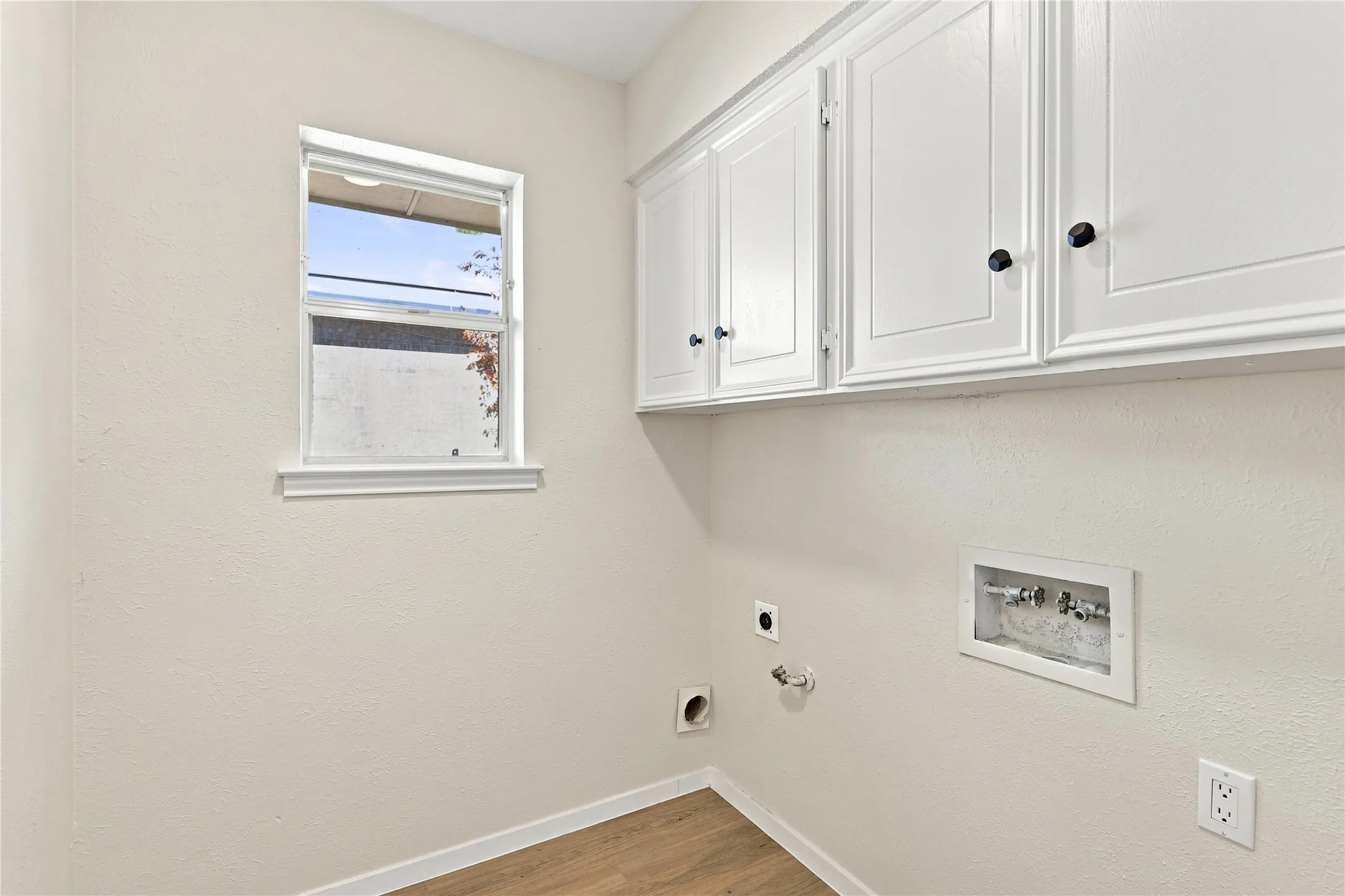 White shaker-style cabinetry with black hardware