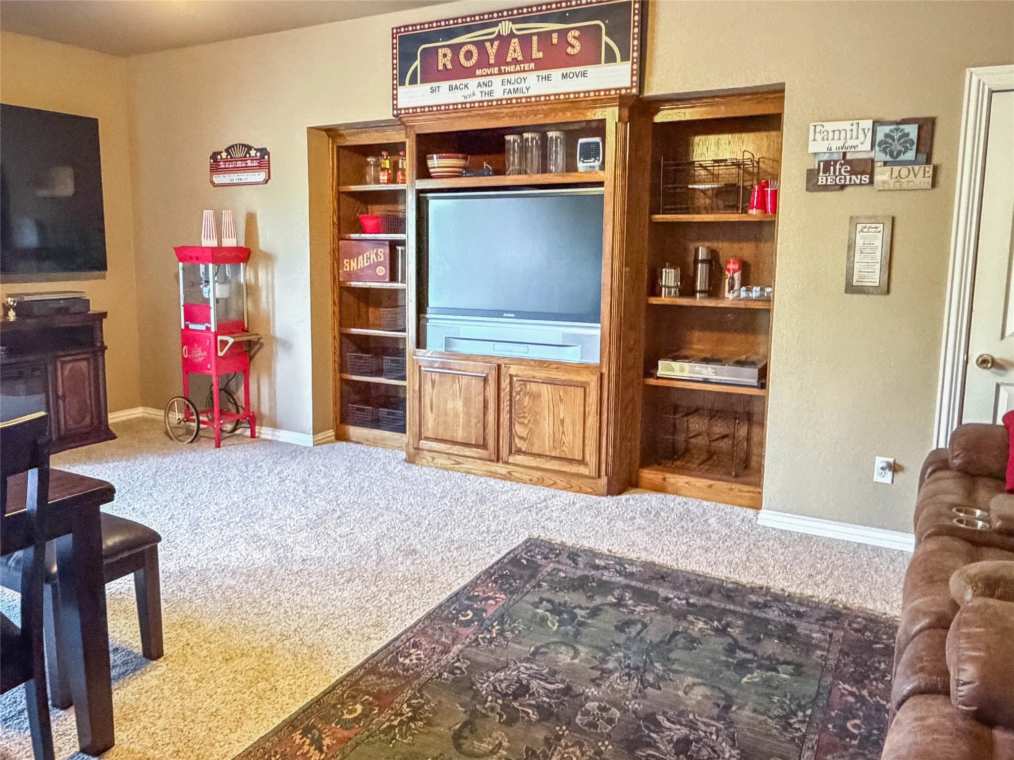 Built-in entertainment center featuring wood-finish cabinetry and integrated shelving