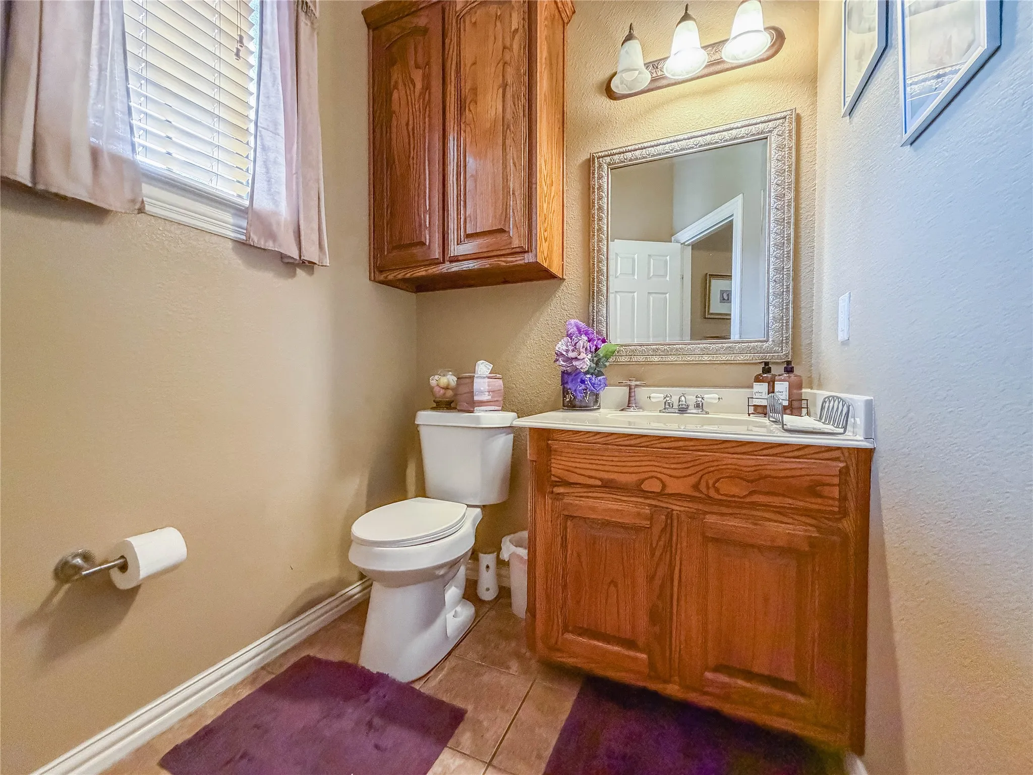Wood-finish vanity with an integrated sink and chrome faucet