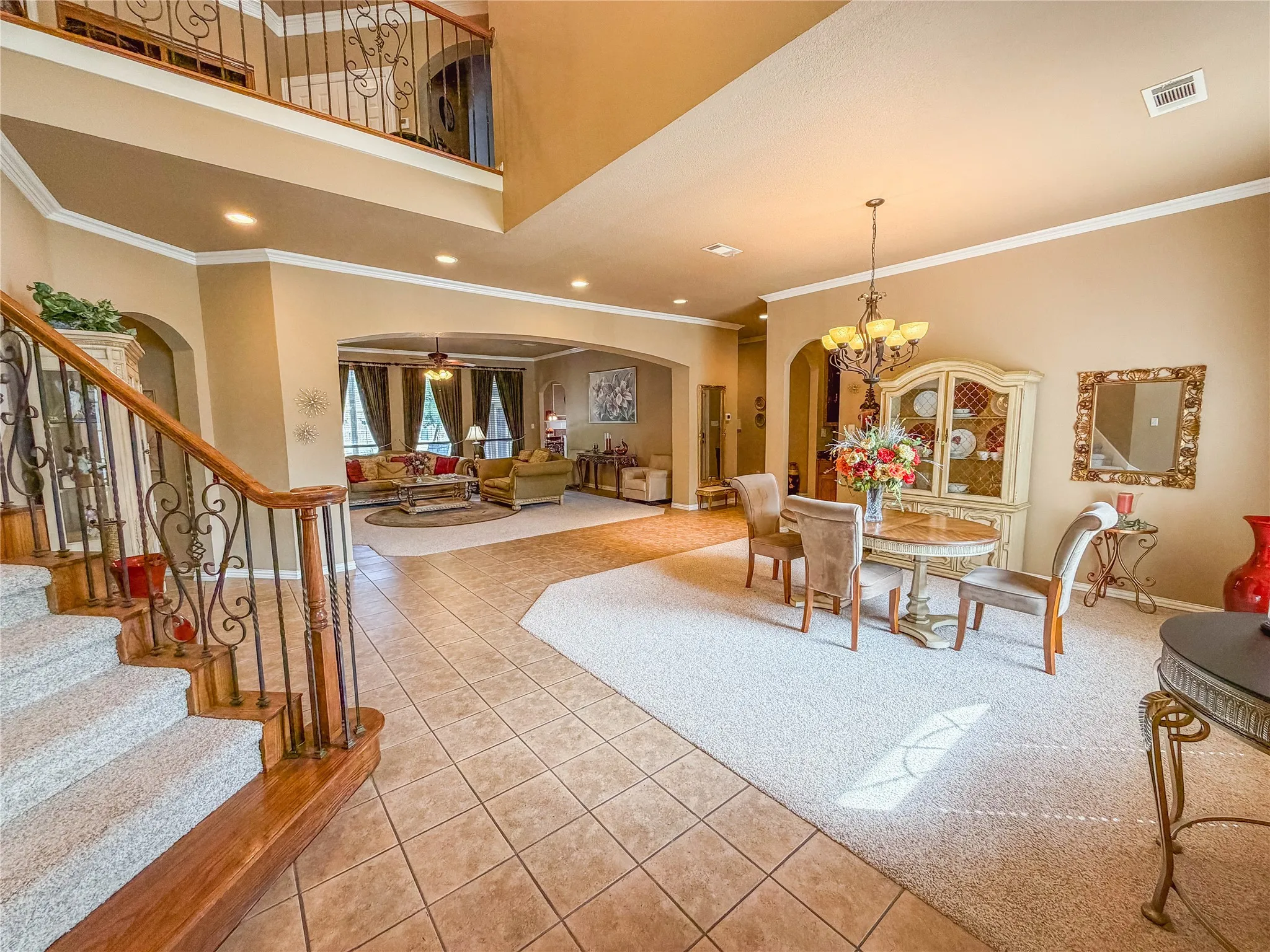Grand foyer with a wood and wrought iron staircase