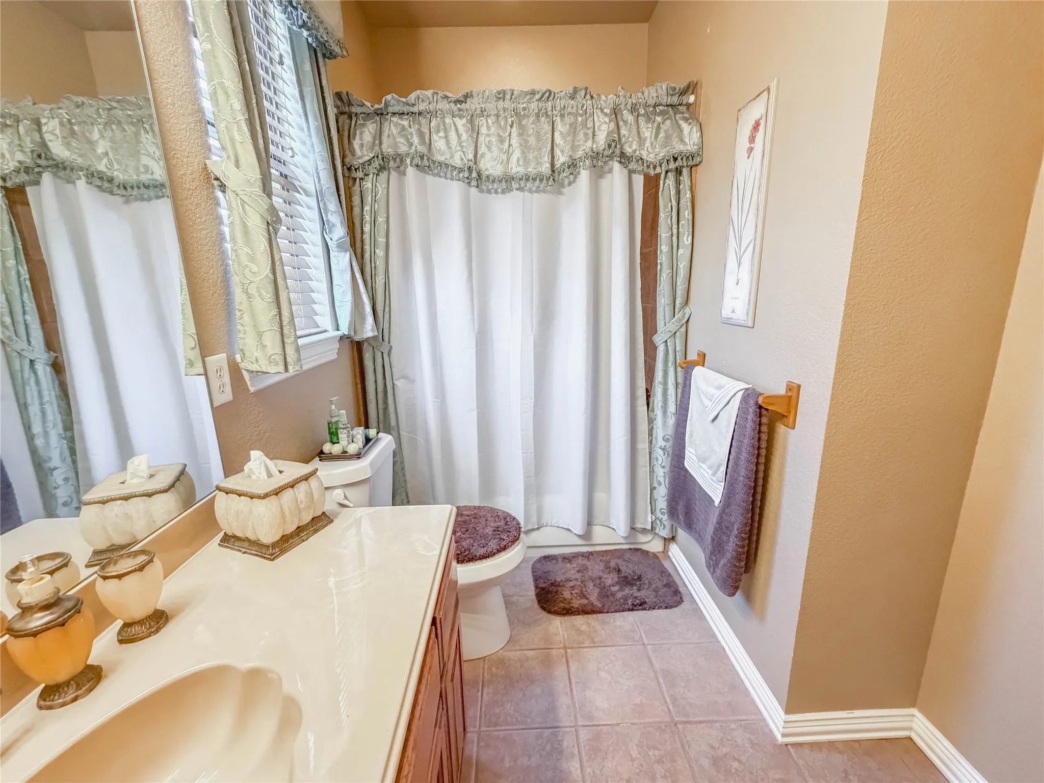 Vanity with an integrated shell-shaped sink, wood-finish cabinetry, and a full-width mirror
