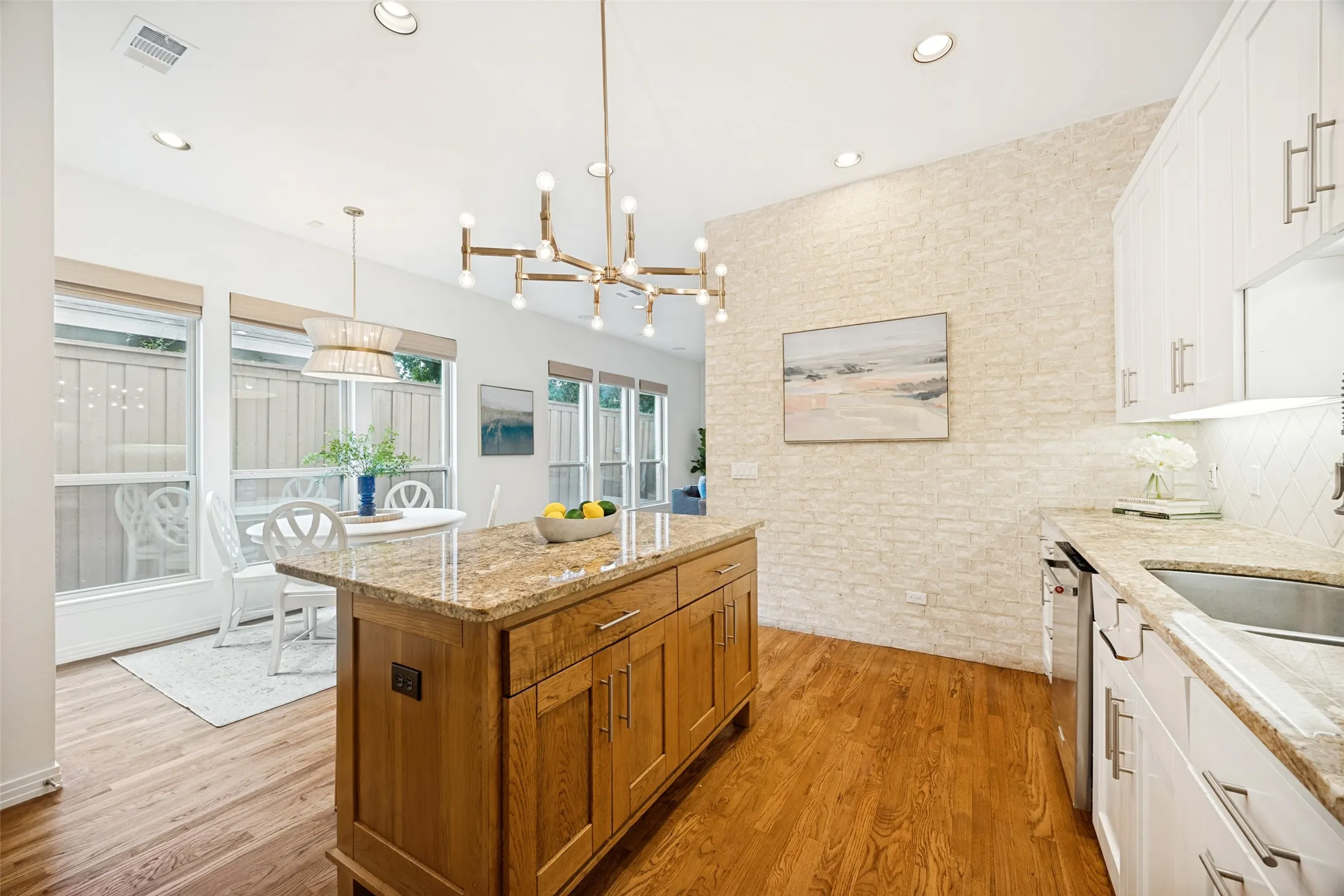 Kitchen flooded with natural light, upgraded lighting and stainless appliances