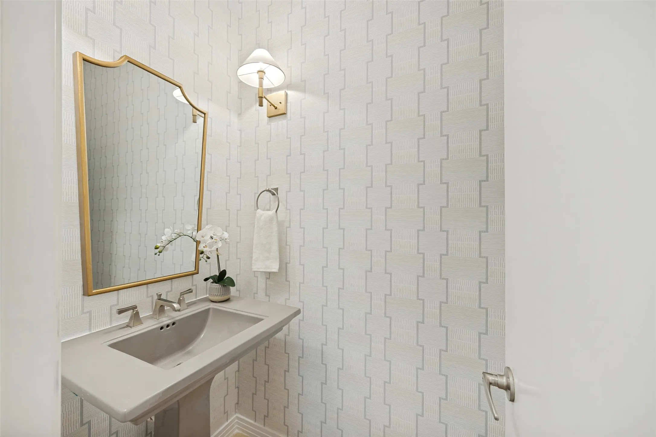 Charming powder bathroom with fresh wallpaper