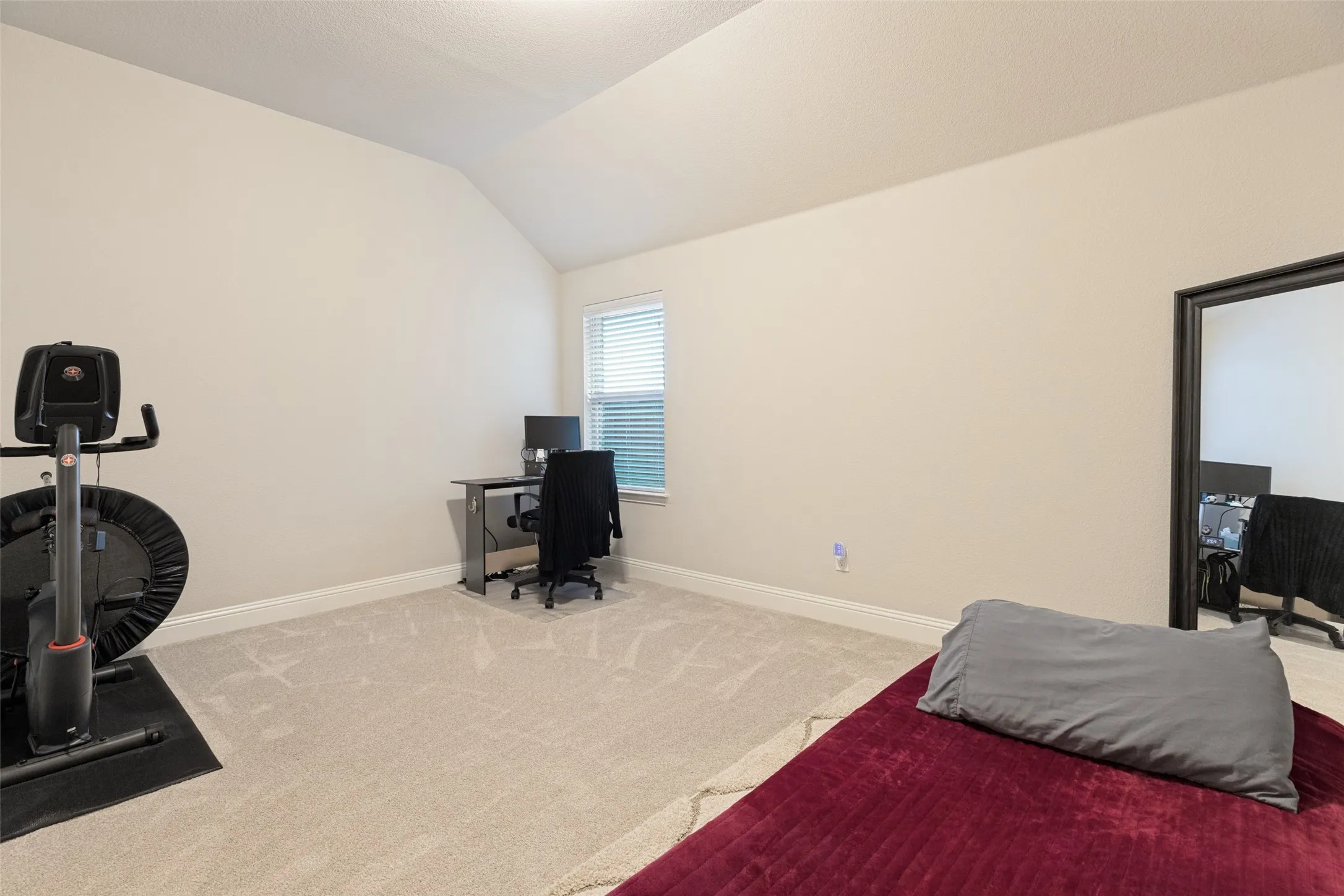 Large bedroom with vaulted ceiling.